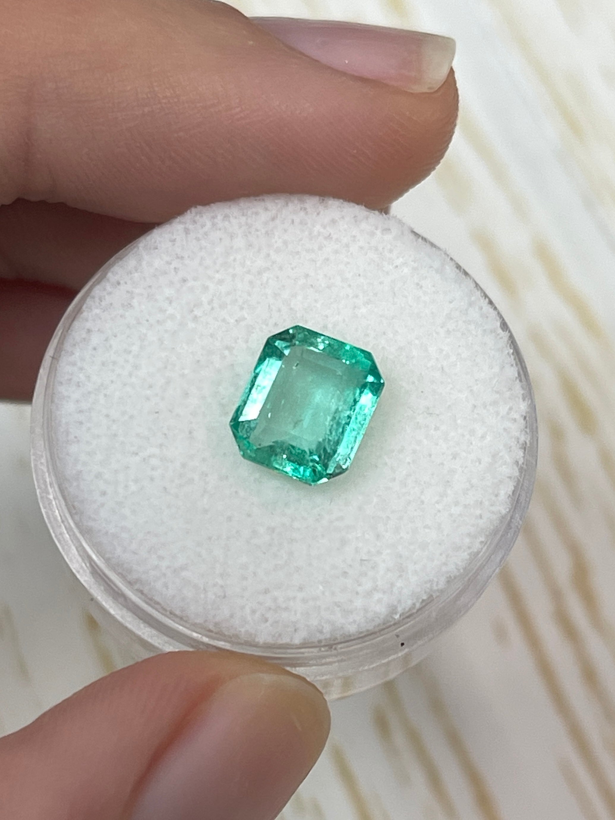 Natural 2.15 carat Colombian emerald in an 8.5x7.5 mm portrait cut, showcasing a chunky, vibrant green loose gemstone.