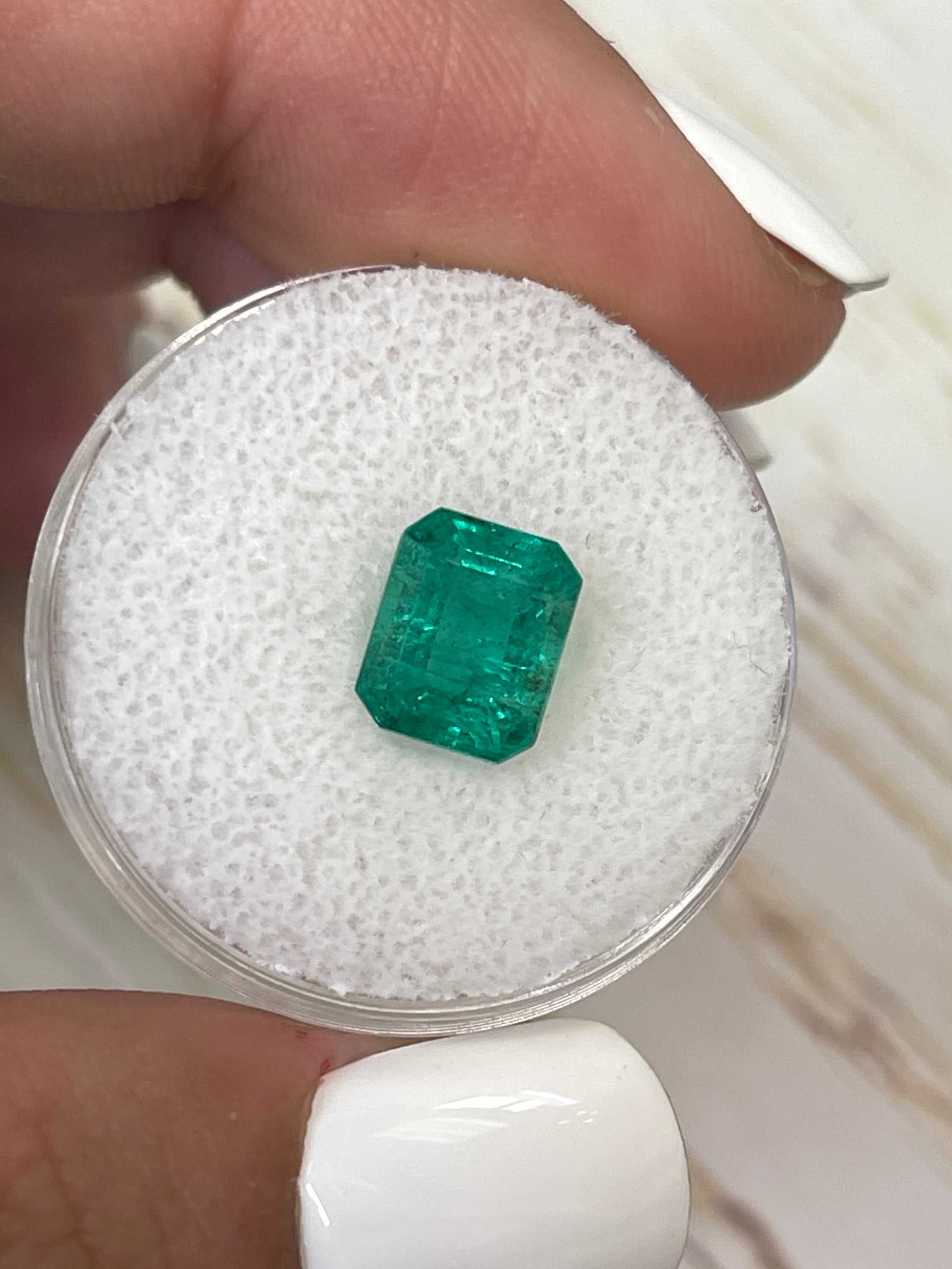 Medium green 2.26 carat natural Zambian emerald in emerald cut, from JR Colombian Emeralds, displayed against a neutral background.