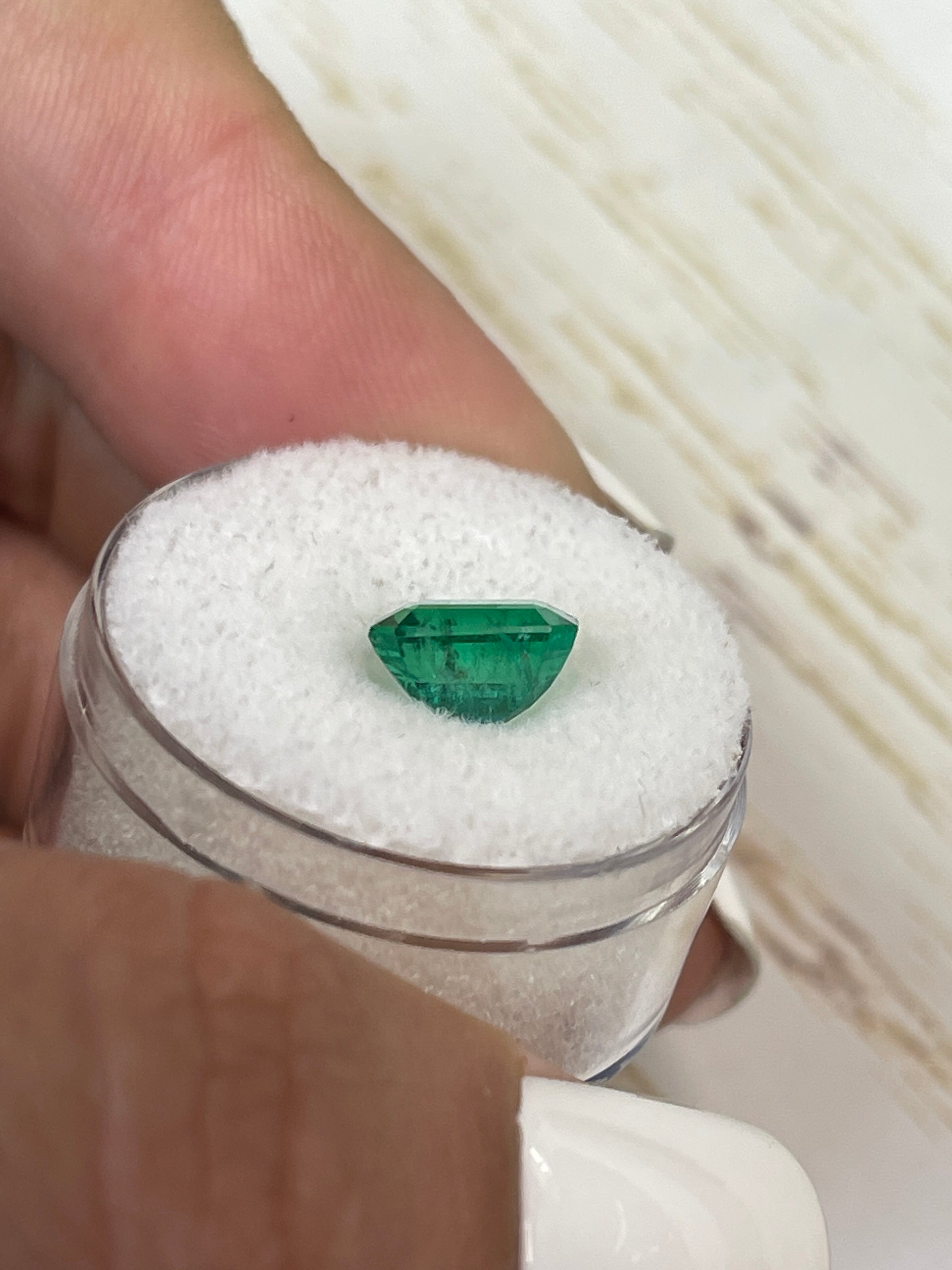 Medium green 2.26 carat natural Zambian emerald in an emerald cut, from JR Colombian Emeralds, displayed on a white background.