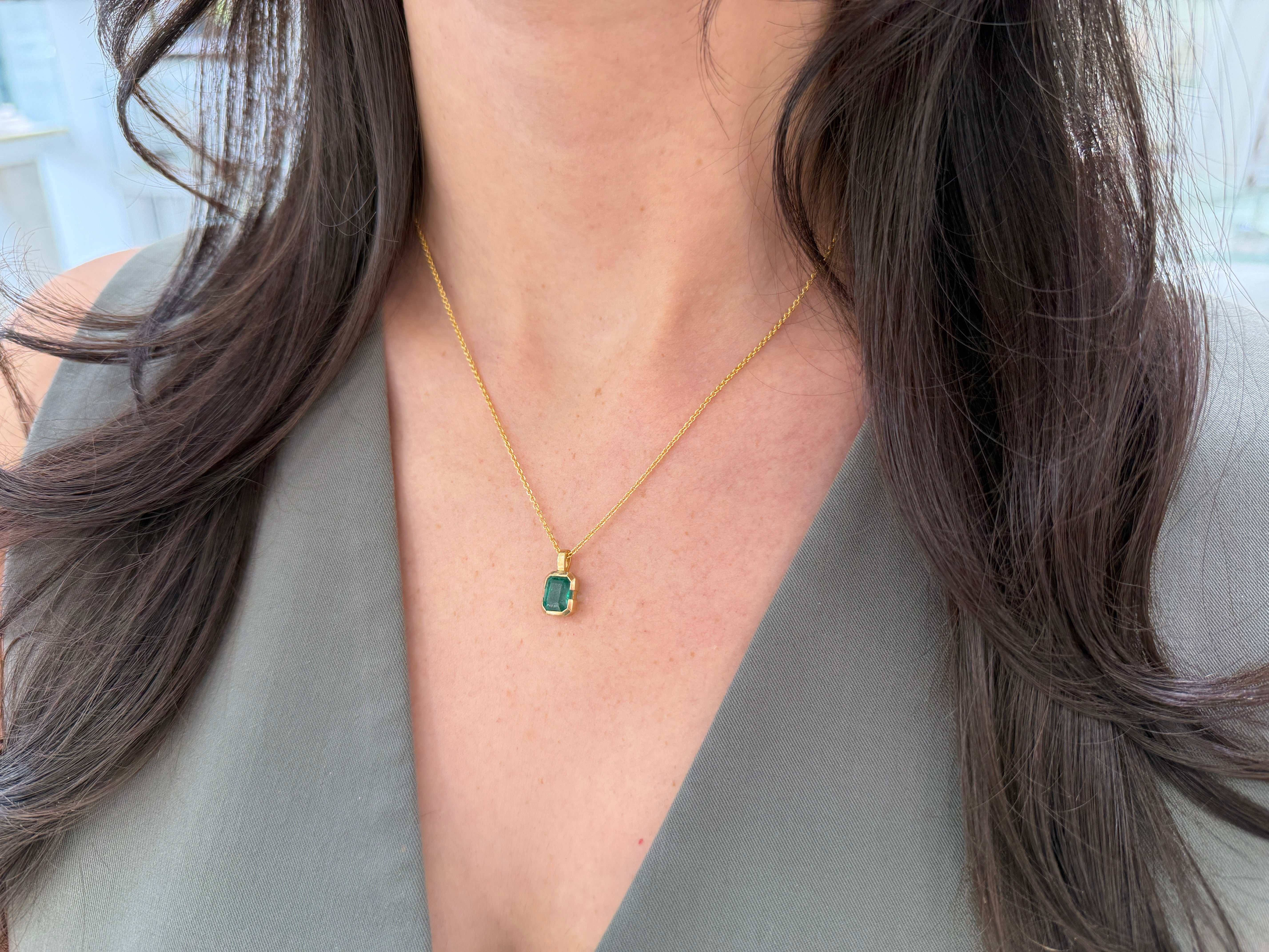 14K gold emerald solitaire necklace with semi-bezel setting and 2.28 carat emerald touches skin, by JR Colombian Emeralds.