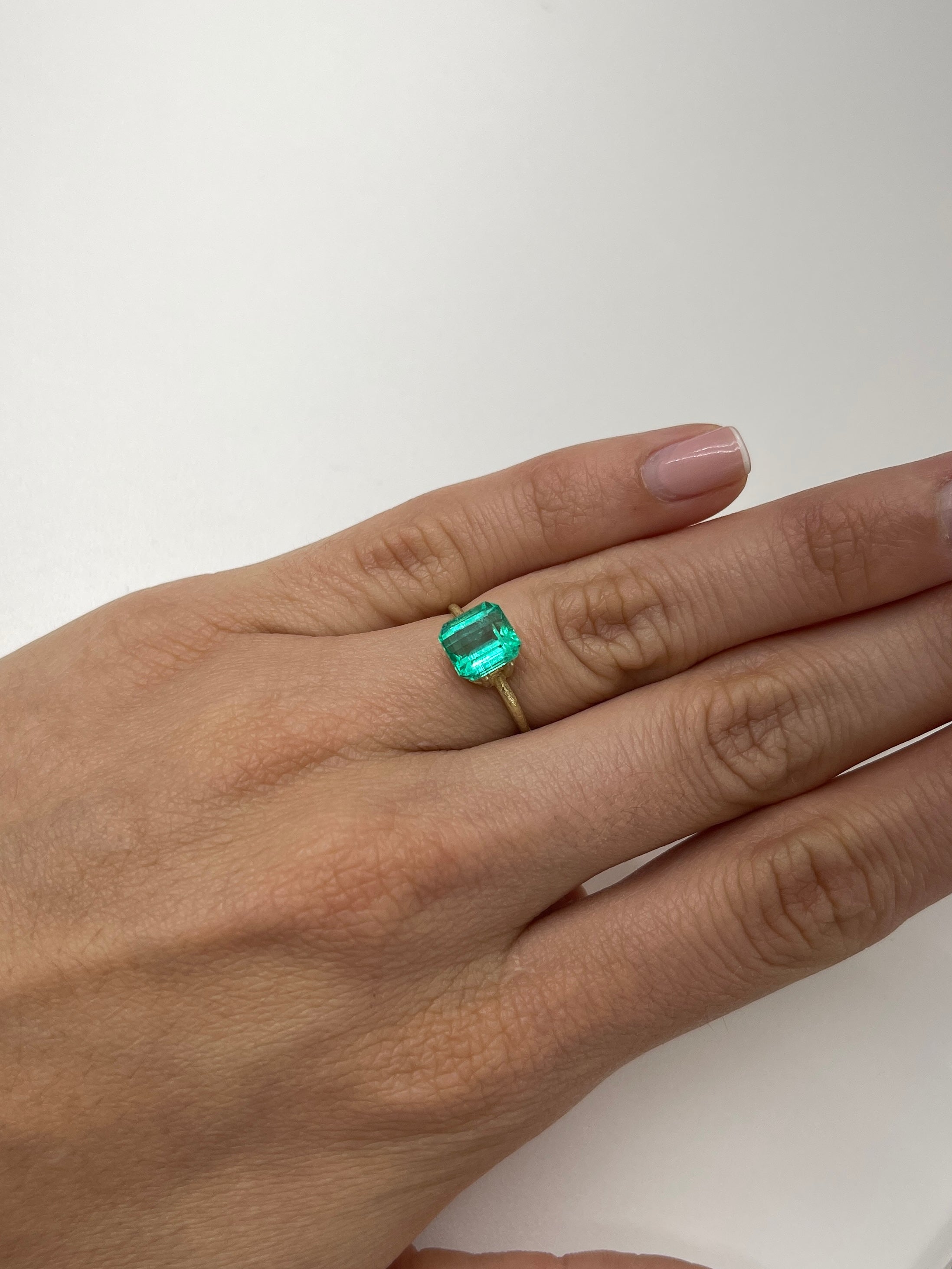 2.36 Carat natural loose Colombian emerald in Asscher cut, showcased by JR Colombian Emeralds, highlighting its vibrant green color.