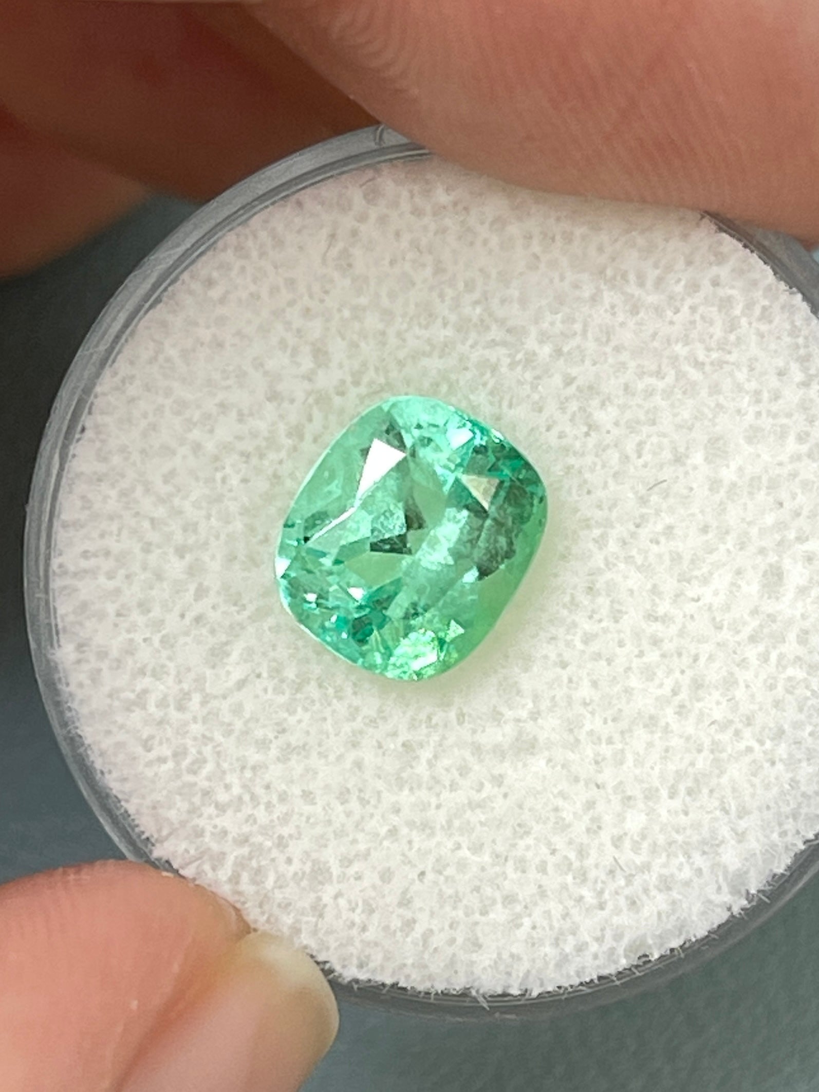Loose 2.41 carat green Colombian emerald with cushion cut, eye clean clarity, natural and eye-catching gemstone from JR Colombian Emeralds.