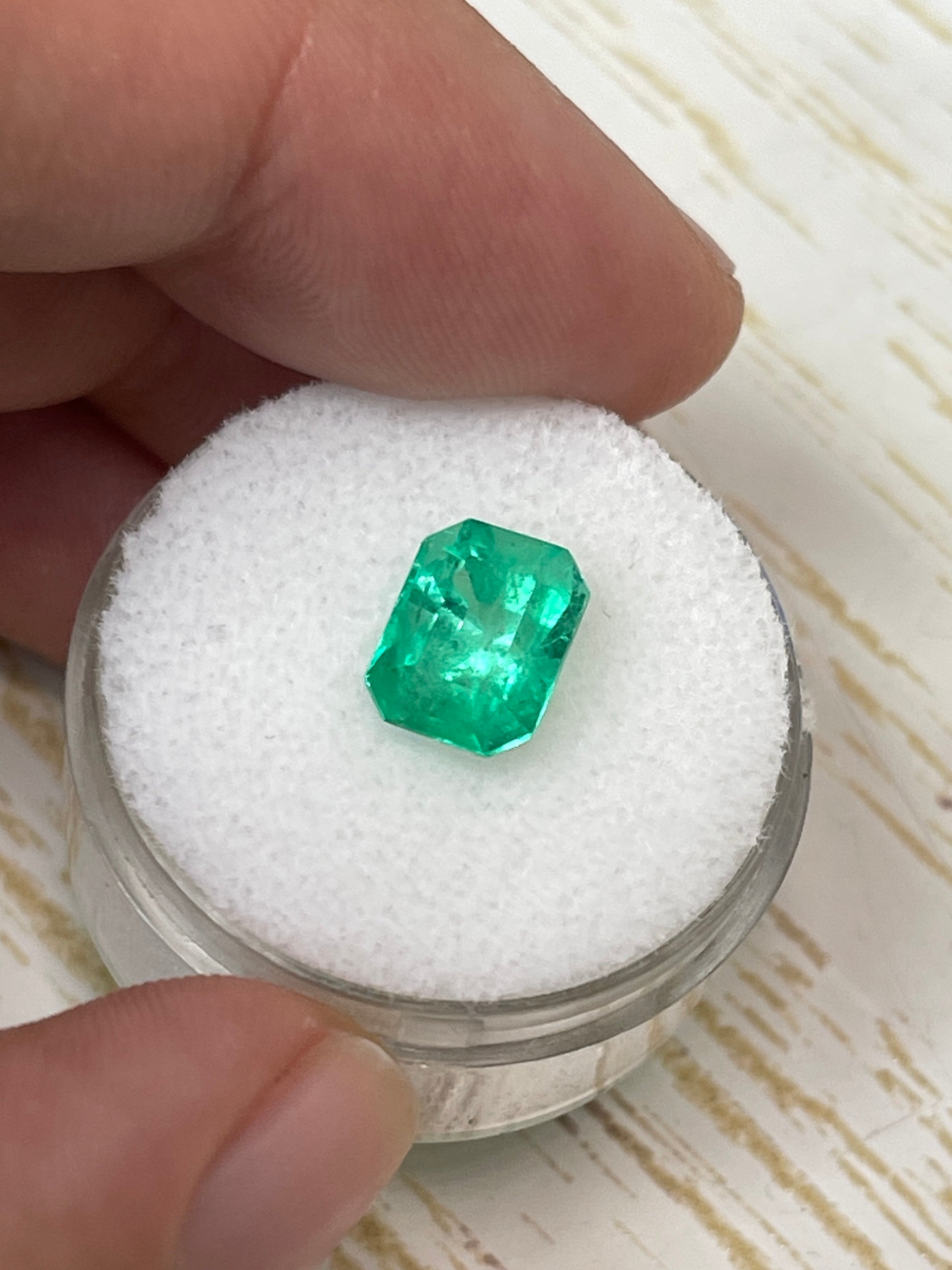 Natural 2.44 Carat 9x7 Spring Green Colombian Emerald loose gemstone in emerald cut, showcasing vibrant green color and clarity.