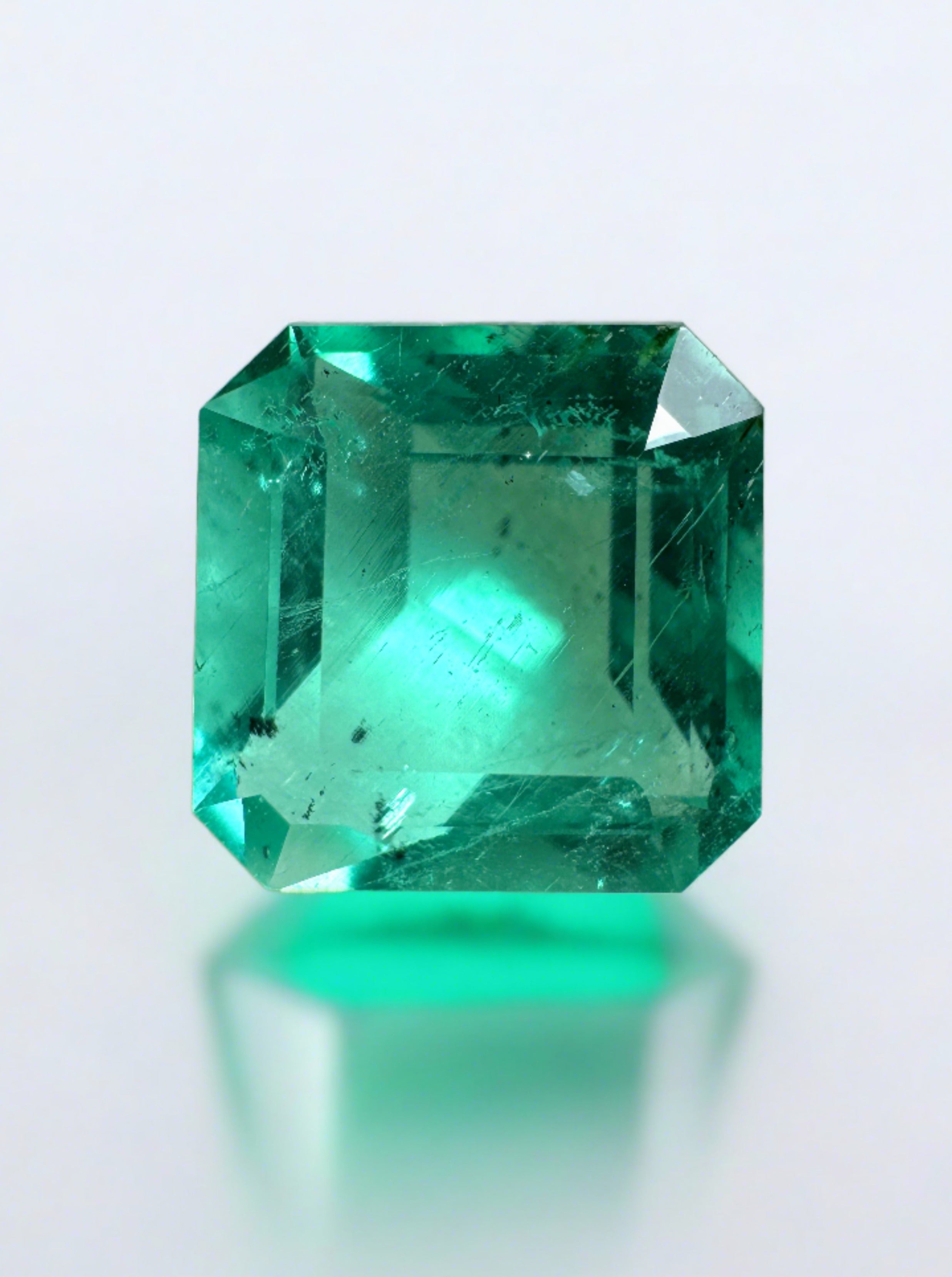Natural 2.44 carat bluish green Colombian emerald in Asscher cut, with natural freckles, from JR Colombian Emeralds.