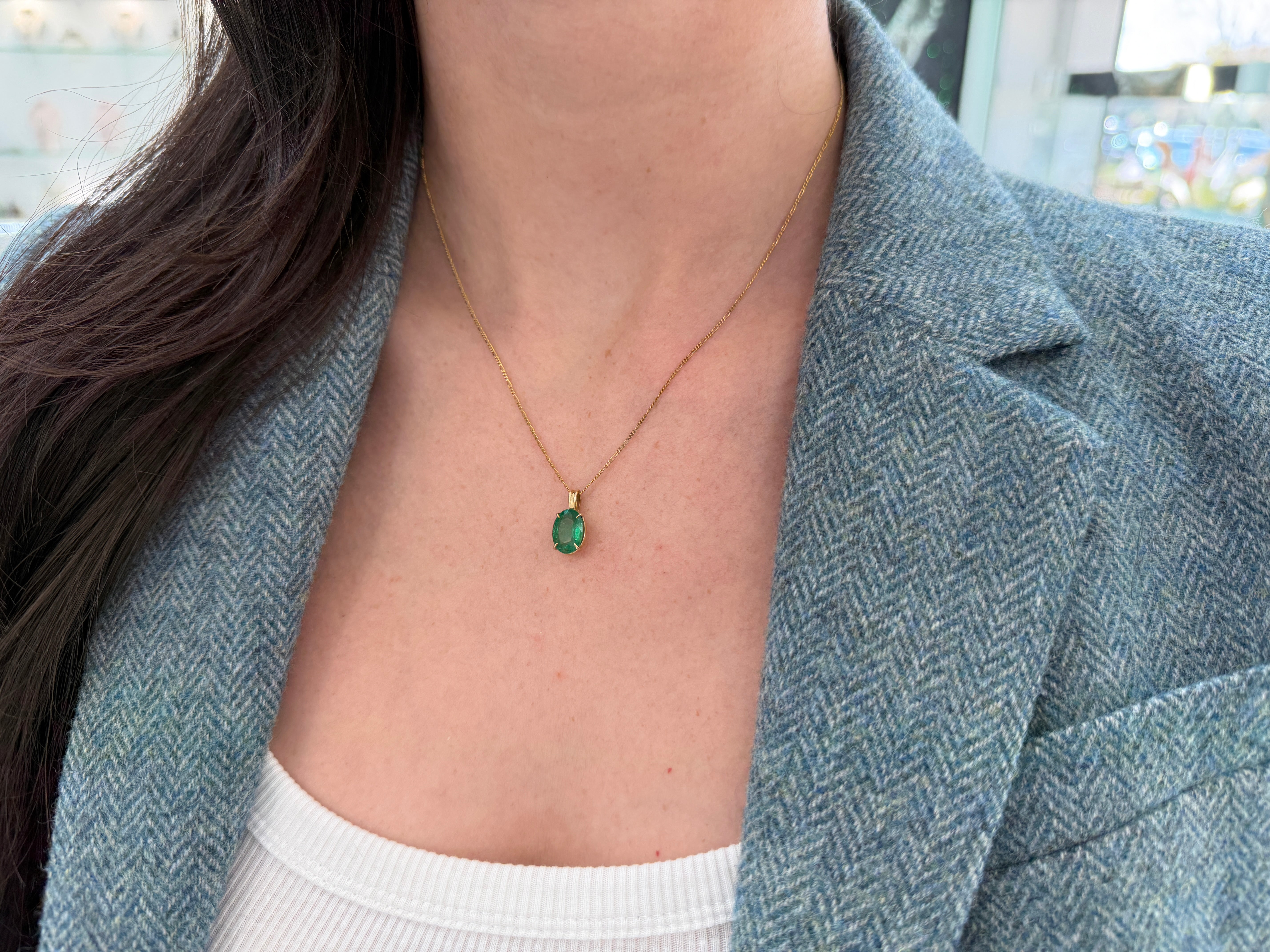 Oval 2.50 carat natural emerald solitaire pendant in 14K gold by JR Colombian Emeralds, showcasing a vibrant green gemstone.