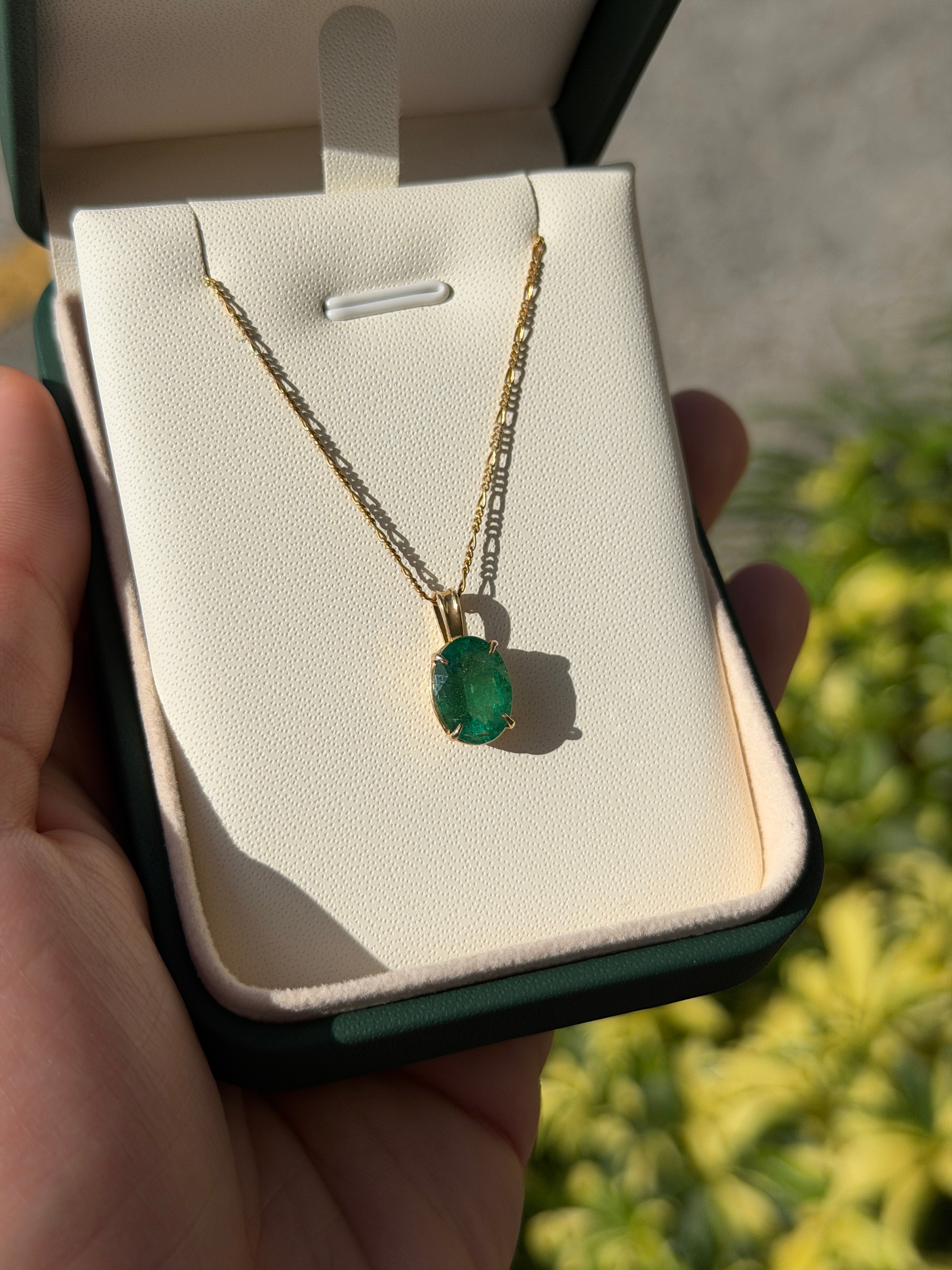 Oval 2.50 carat natural emerald solitaire pendant in 14K gold by JR Colombian Emeralds, showcasing the vibrant green gemstone.