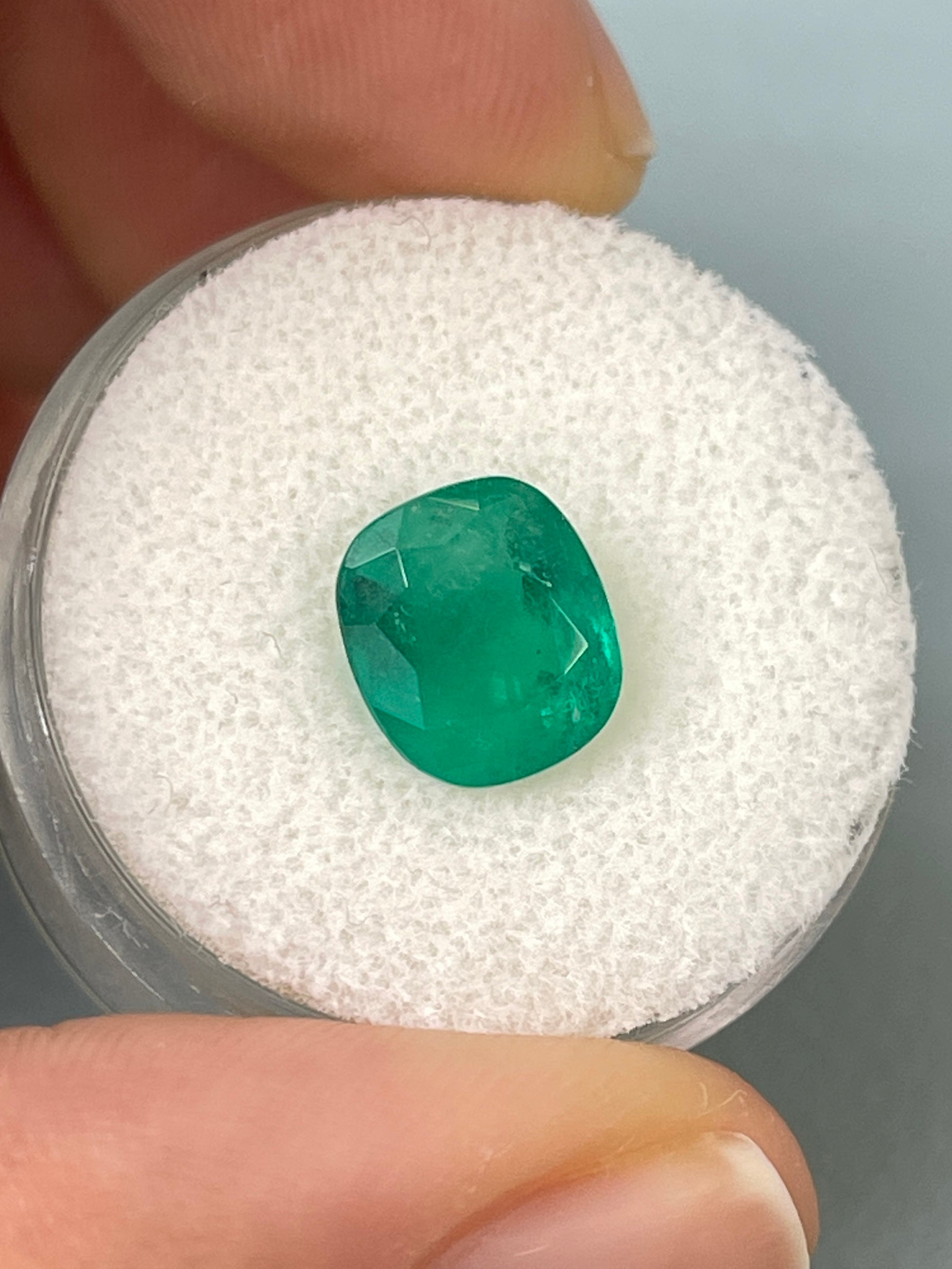 Deep green 2.55 carat natural Colombian emerald in cushion cut, showcasing rich color and clarity, from JR Colombian Emeralds.