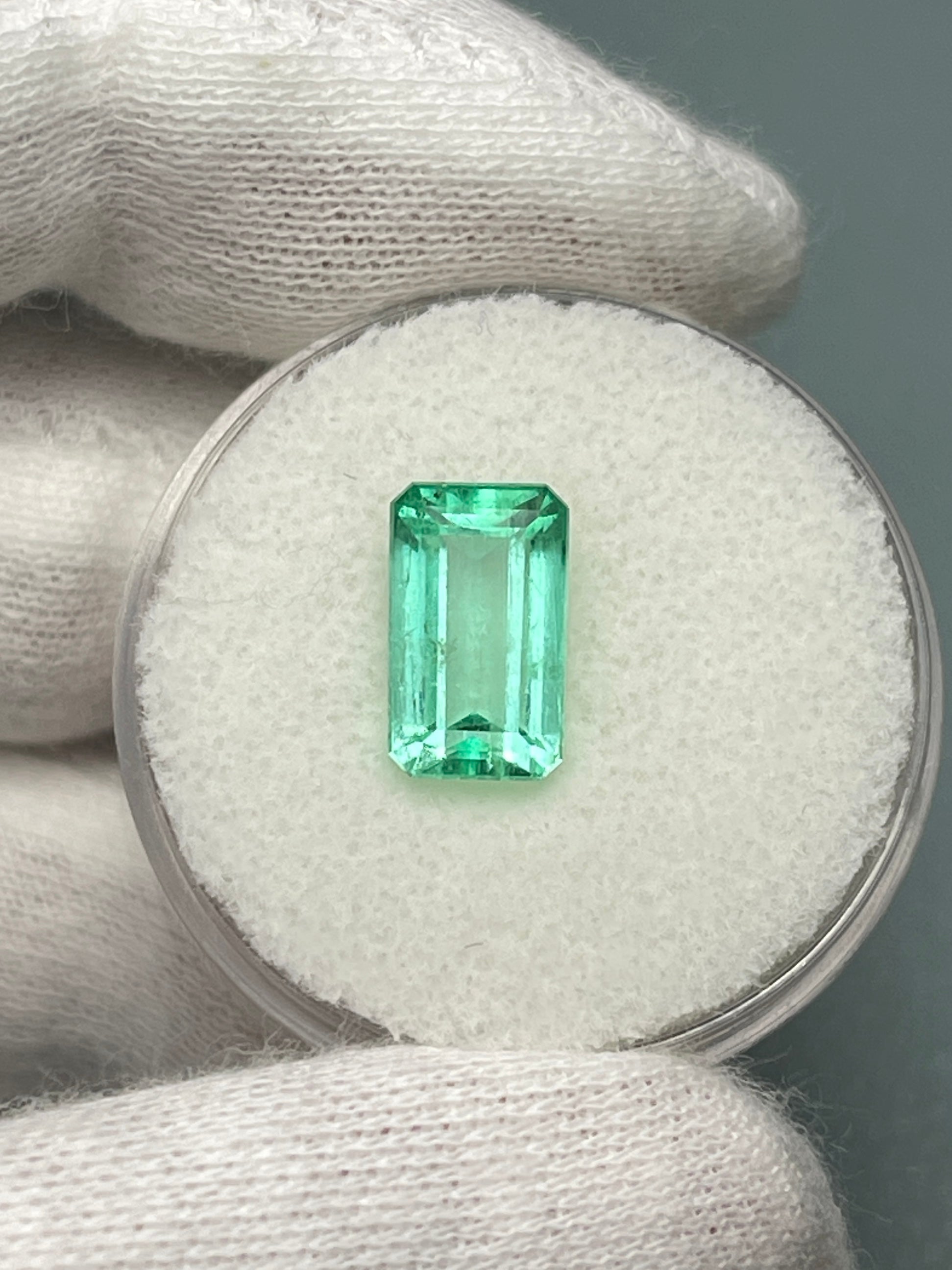 2.64 carat emerald cut Colombian emerald with pastel yellowish-green color, loose gemstone from JR Colombian Emeralds.