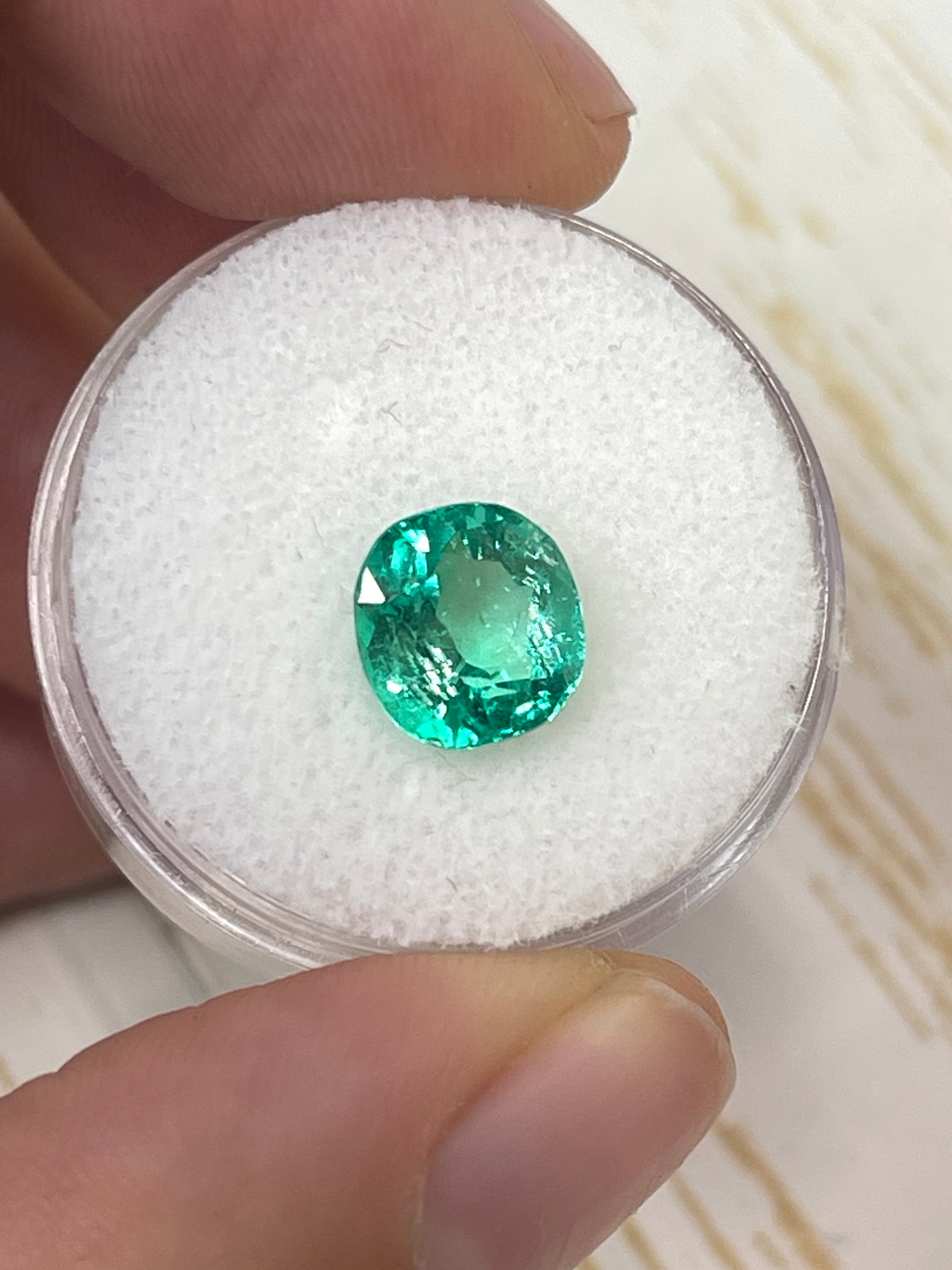 2.67 Carat glowing Muzo green Colombian emerald loose cushion cut gemstone with vibrant natural color and high clarity.