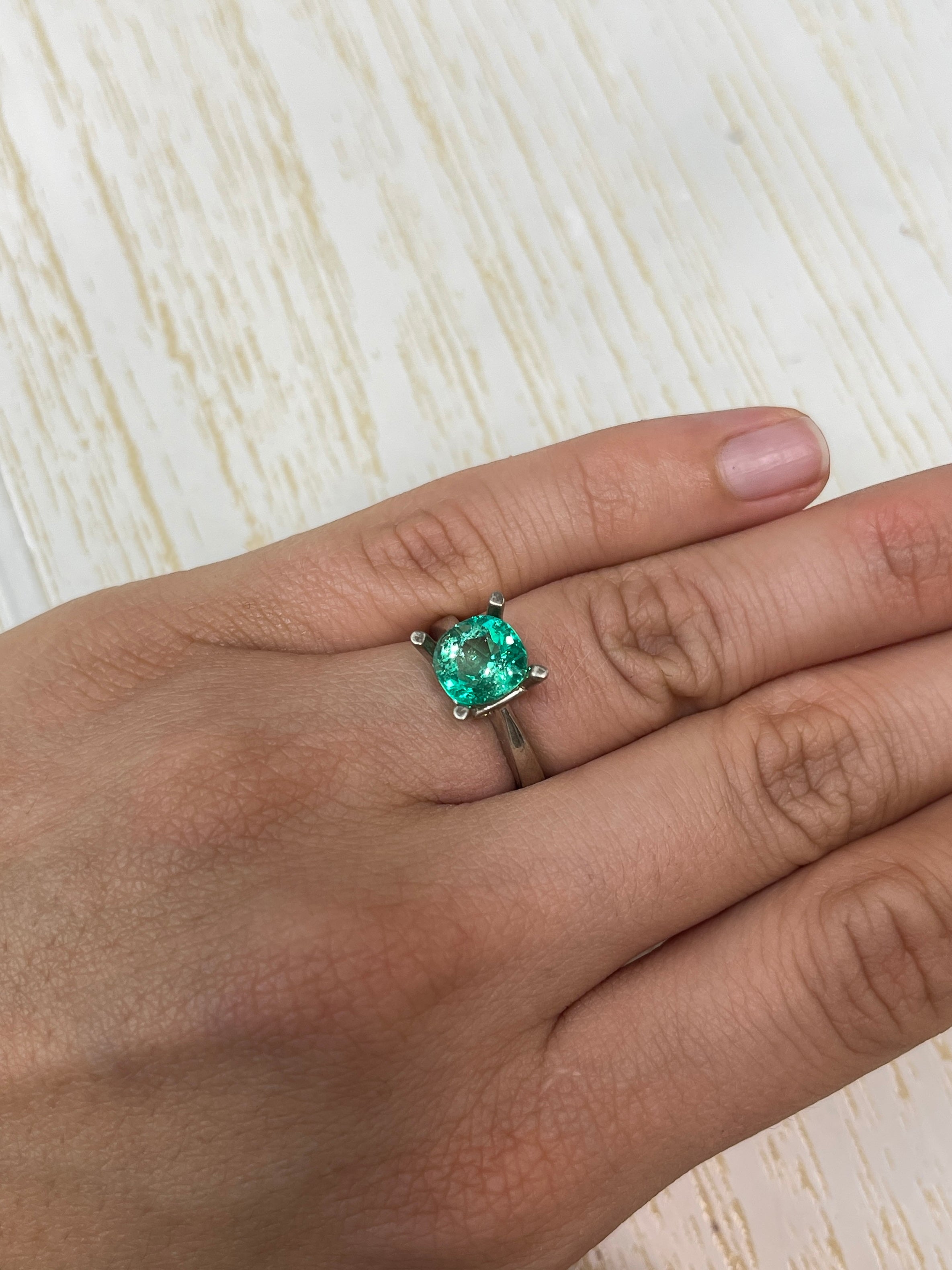 2.67 carat glowing Muzo green Colombian emerald, cushion cut, natural loose gemstone with vibrant green color.