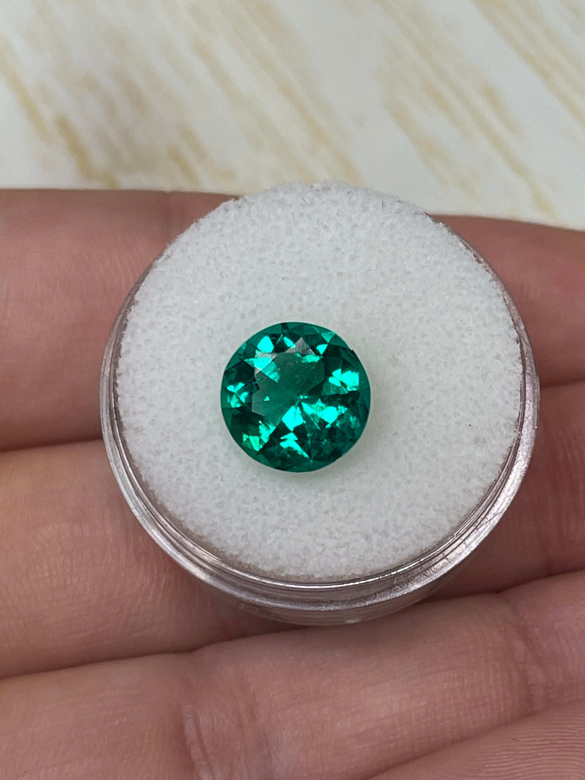 Round 2.71 carat AAA+ Colombian emerald loose gemstone with a drop of oil appearance, natural and vibrant in color.