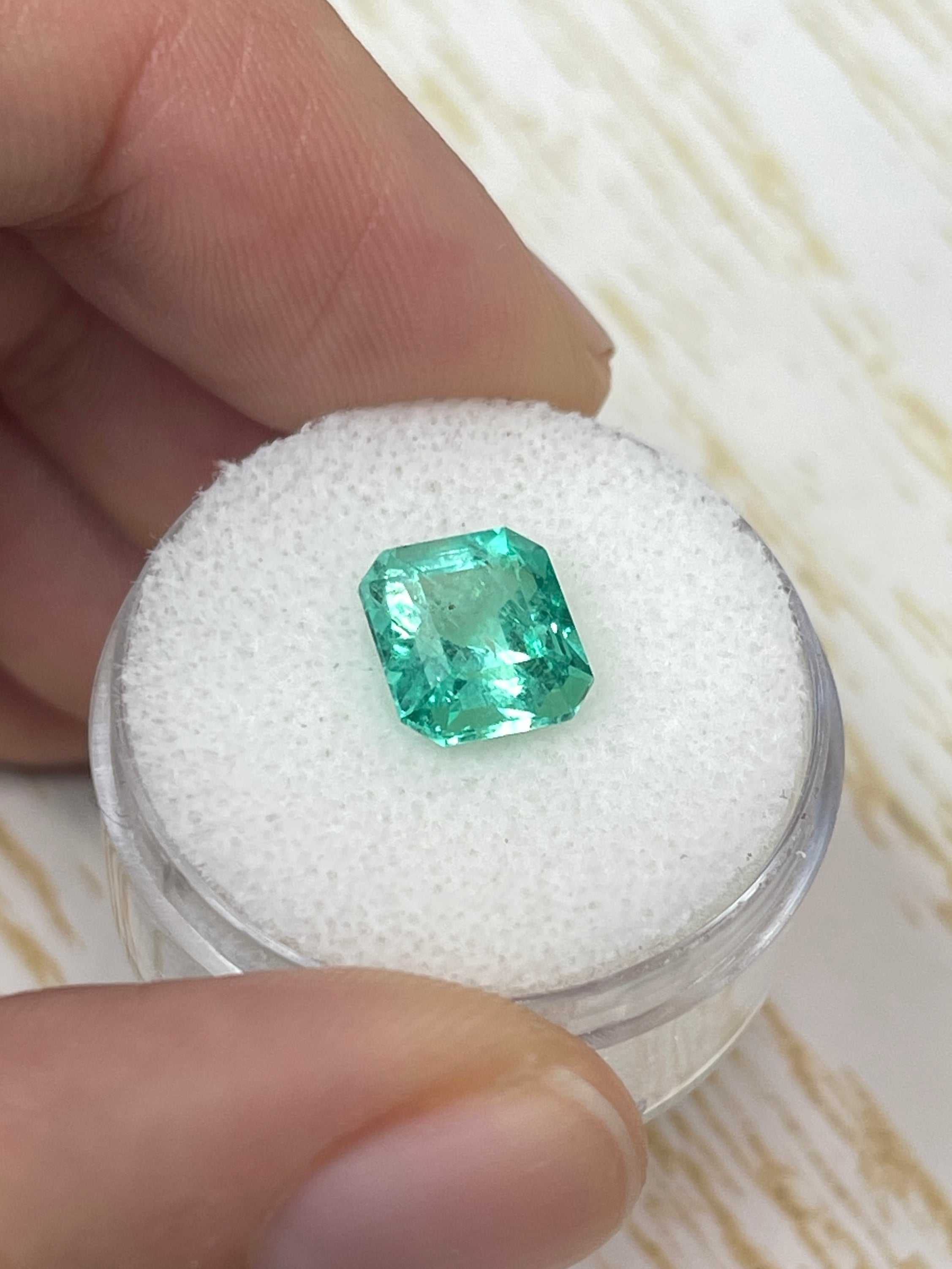 Natural loose Colombian emerald with emerald cut, 2.73 carats, set in a custom lab diamond solitaire engagement ring by JR Colombian Emeralds.