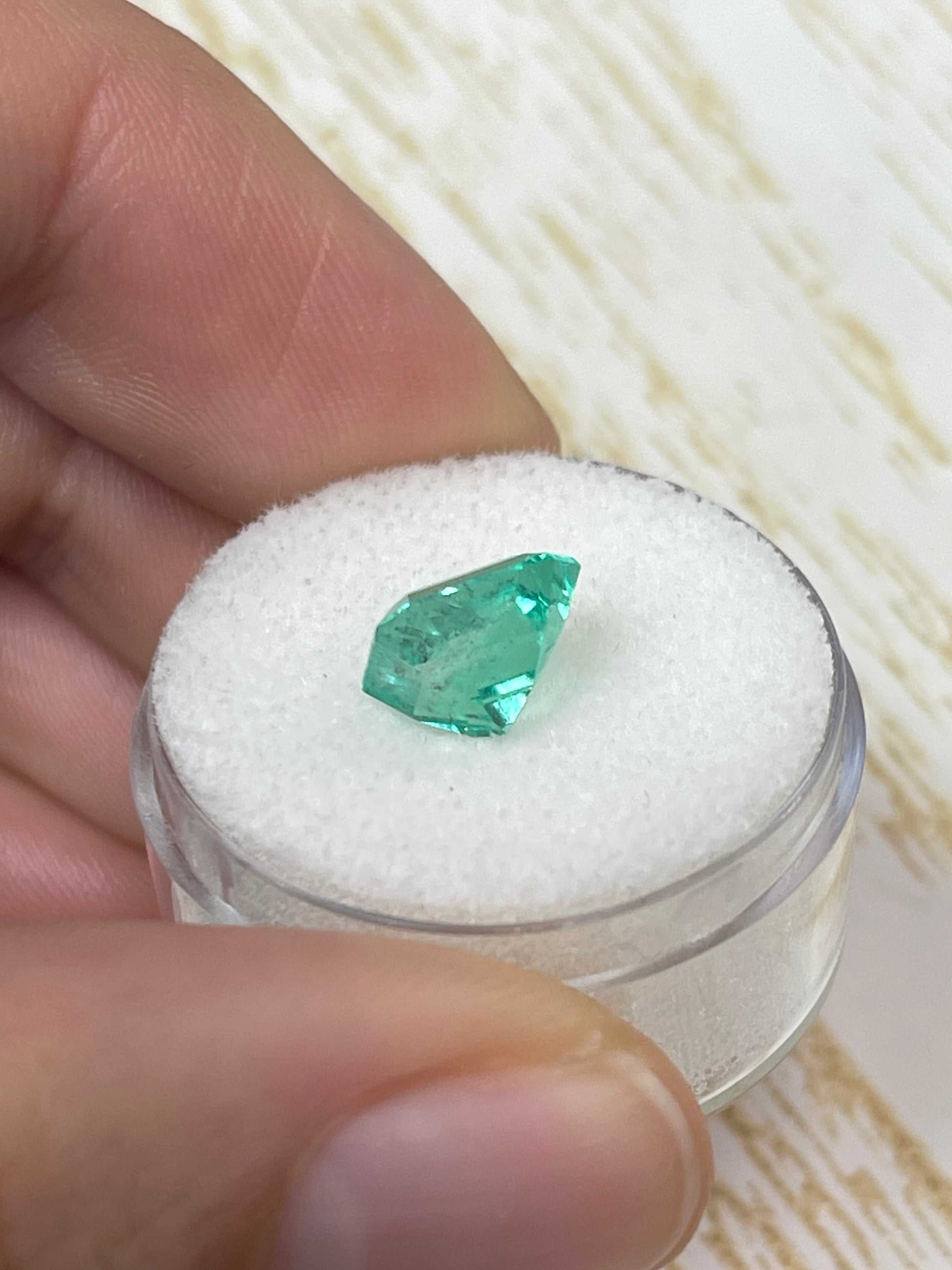 Loose 2.73 carat green Colombian emerald in an emerald cut, set in a custom JR Colombian Emeralds solitaire engagement ring.