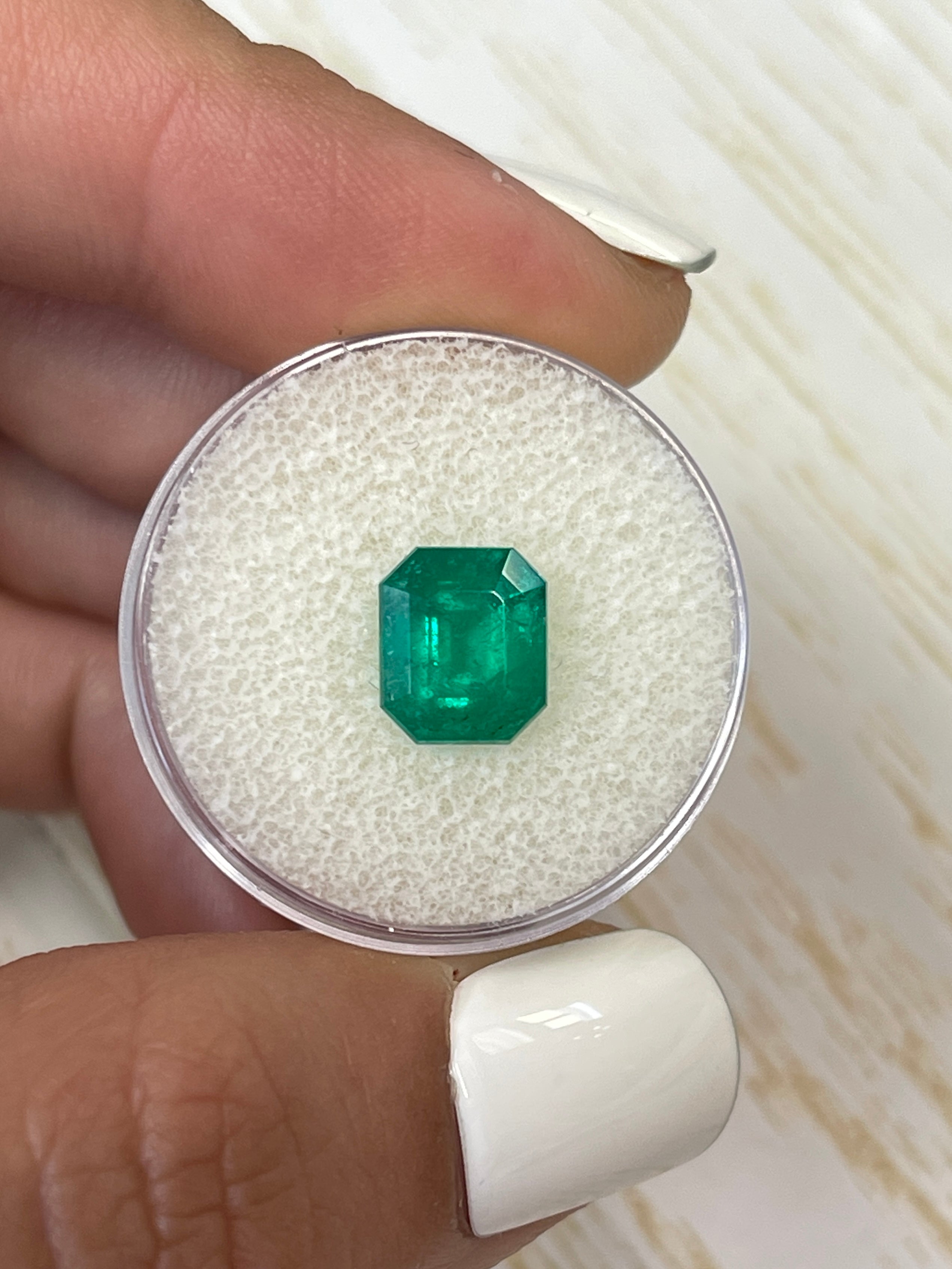 Deep bluish green 2.74 carat natural Colombian emerald in an emerald cut, showcasing vibrant color and clarity.