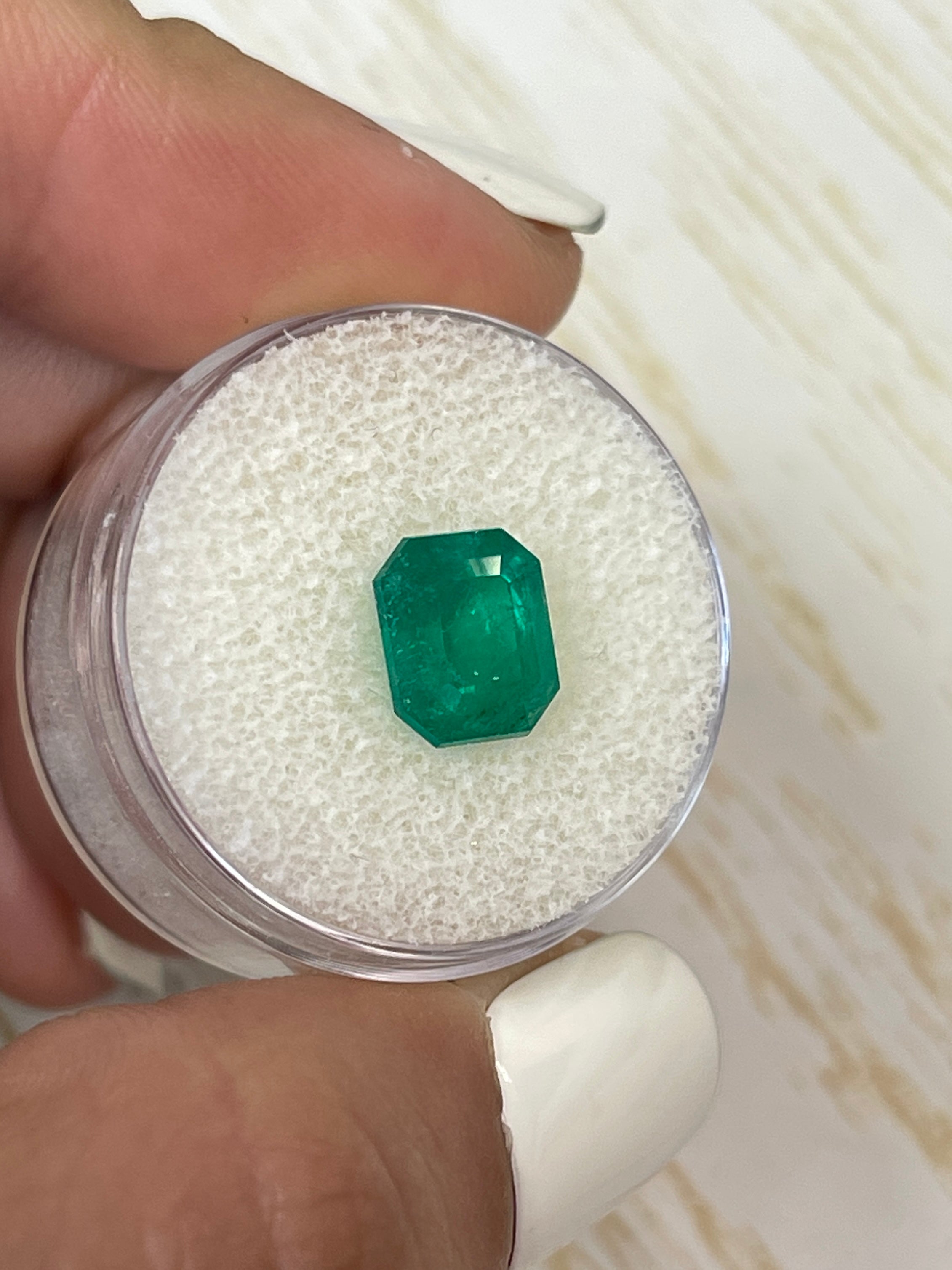 Deep bluish green 2.74 carat natural Colombian emerald in emerald cut, showcasing clarity and vibrant color.