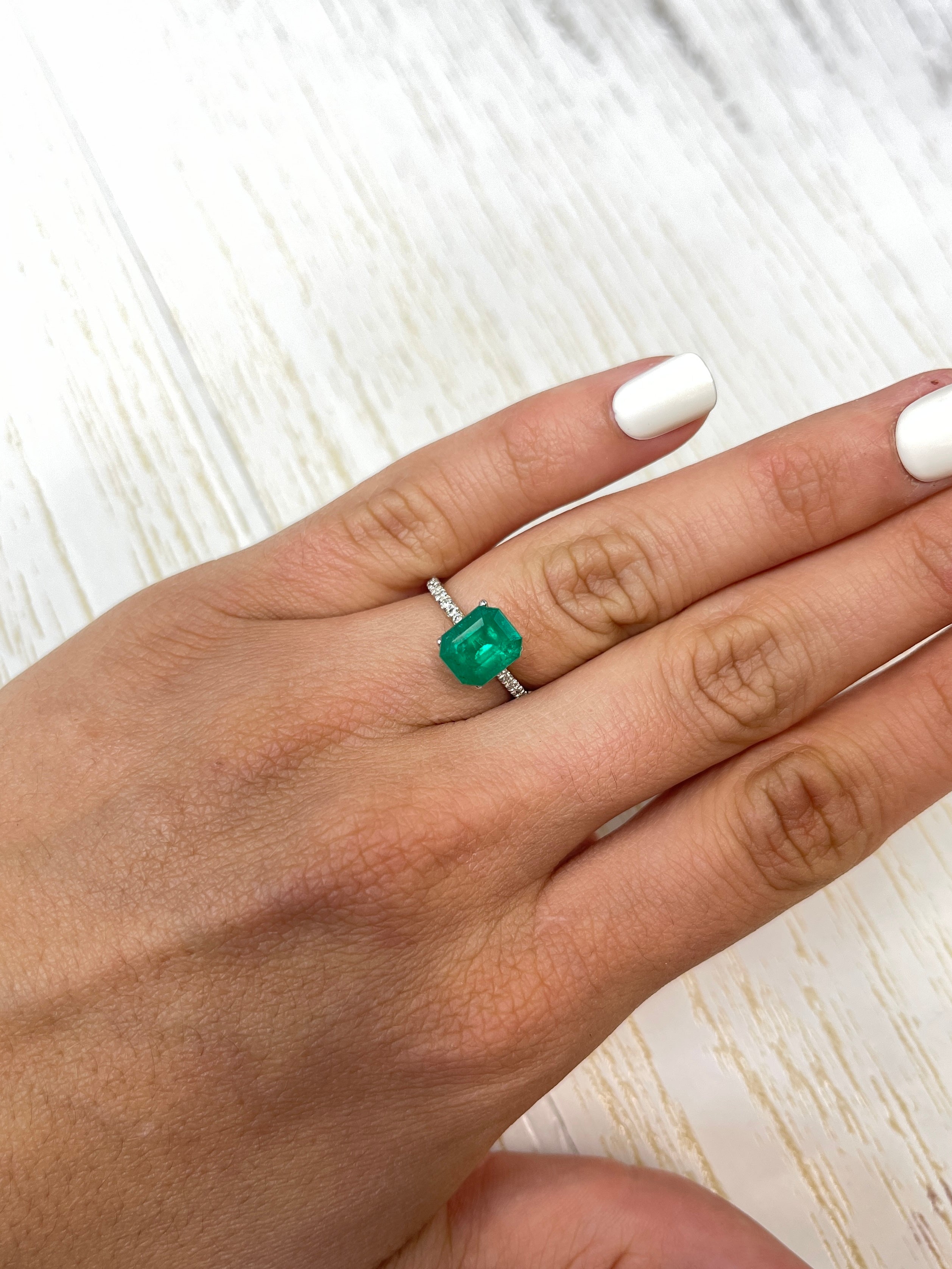 Deep bluish-green 2.74 carat natural Colombian emerald loose gemstone in an emerald cut.