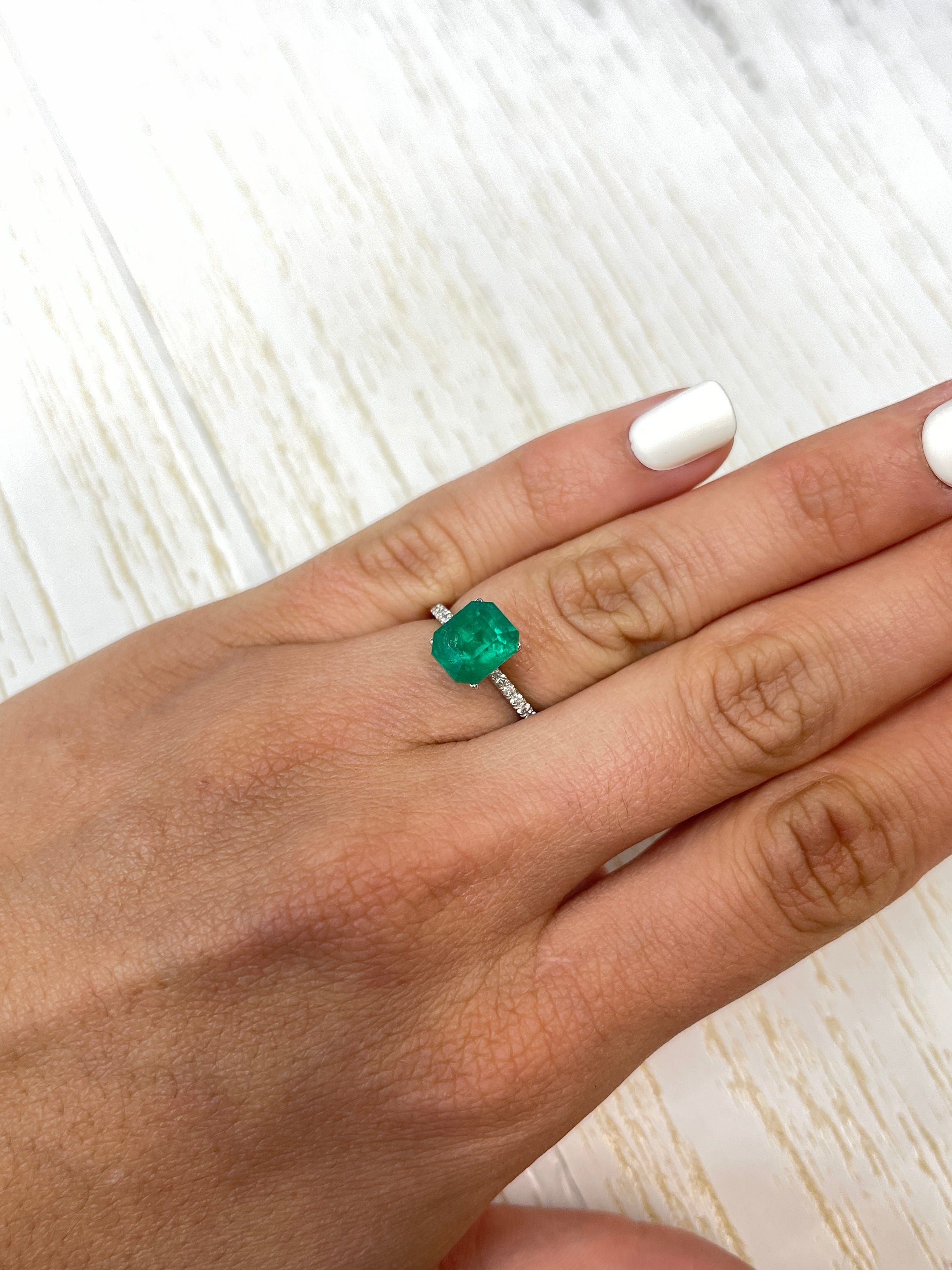 Deep bluish green 2.74 carat natural Colombian emerald in an emerald cut, showcasing vibrant color and clarity.
