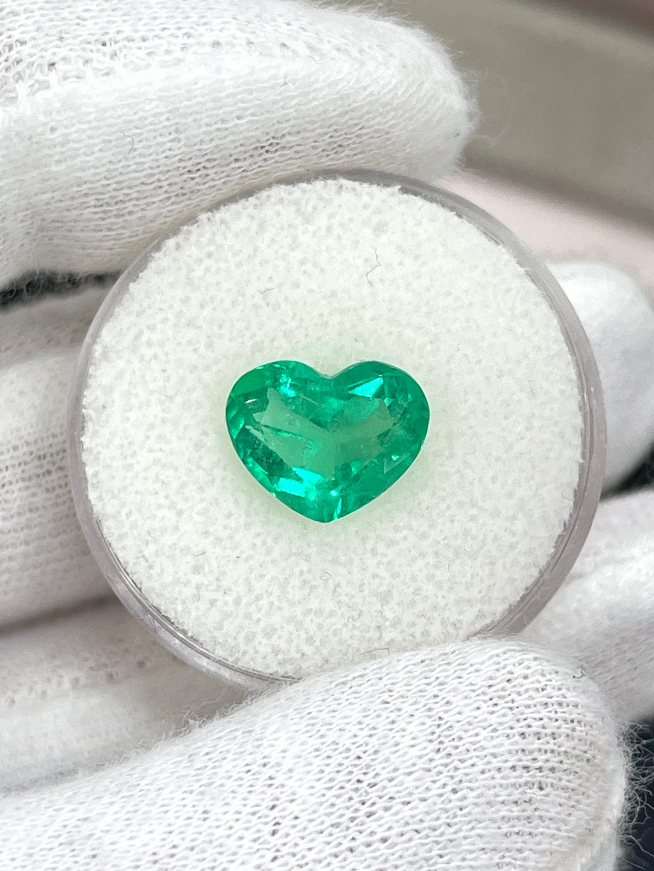 Bright medium green 2.76 carat Colombian emerald loose heart cut gemstone, natural and radiant in appearance.