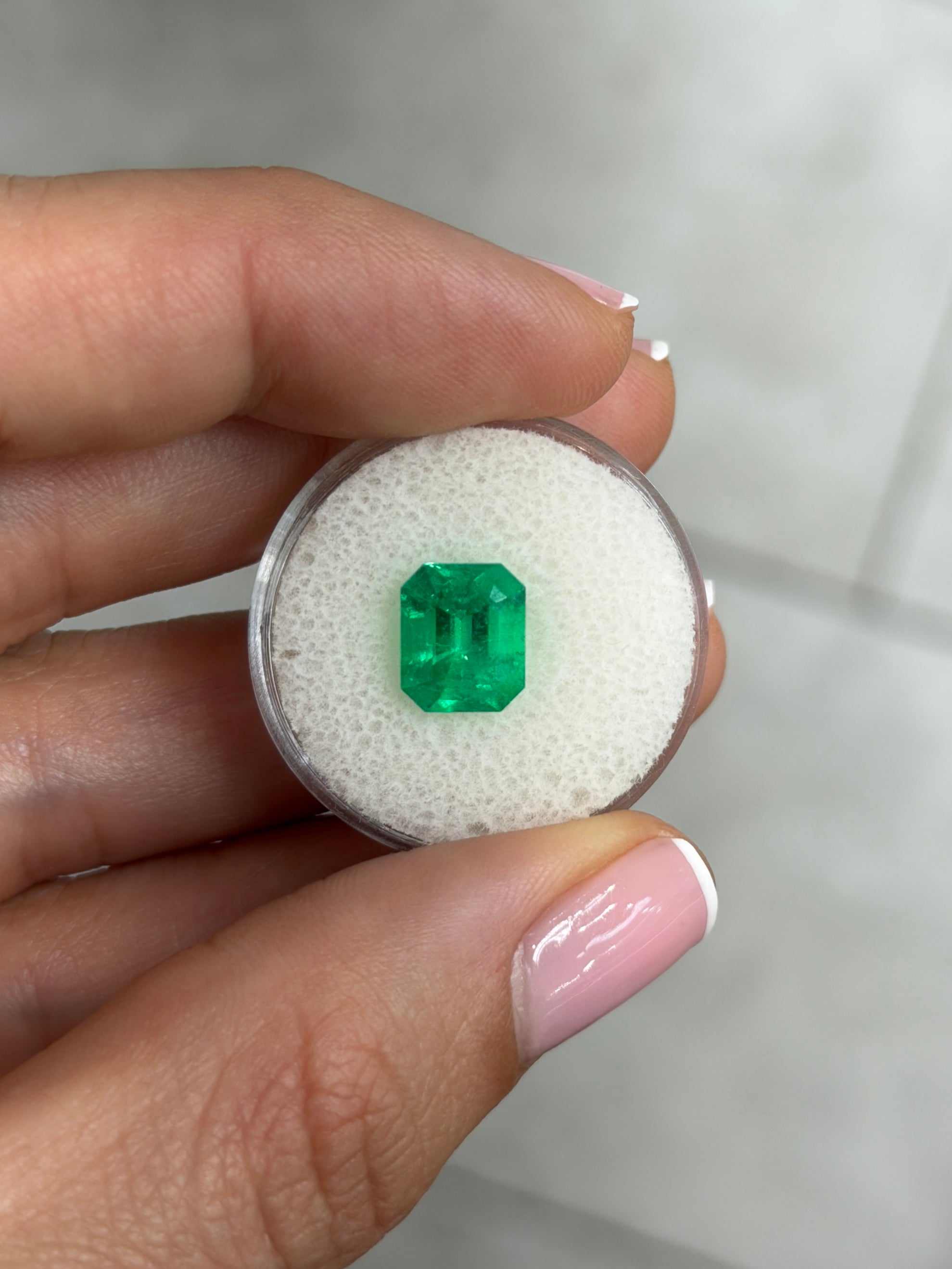 2.80 carat Kryptonite vivid green natural Colombian emerald in an emerald cut, displayed as a loose gemstone by JR Colombian Emeralds.