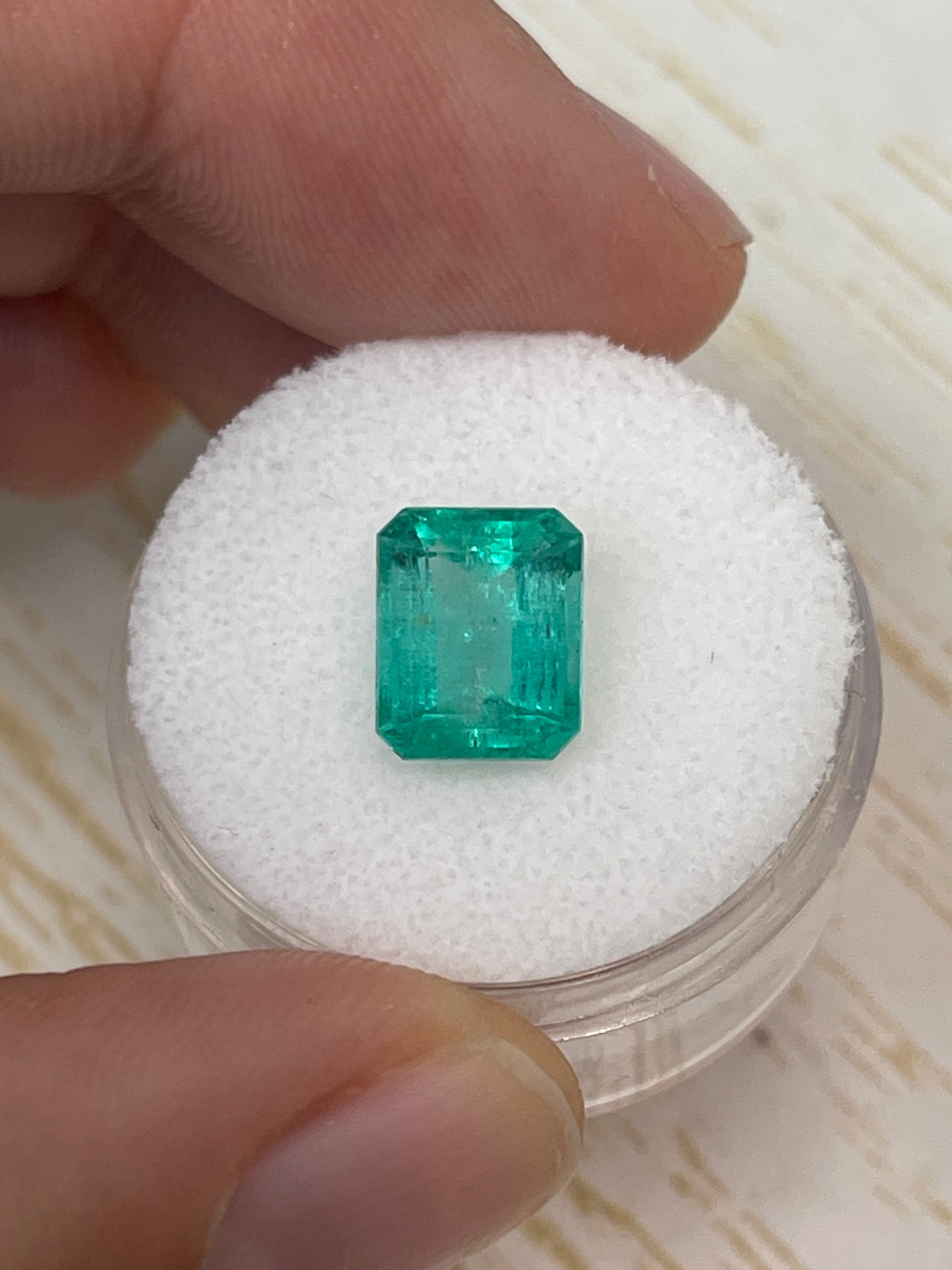 2.84 carat natural Colombian emerald loose gemstone in an emerald cut, showcasing vibrant green color and chunky size.