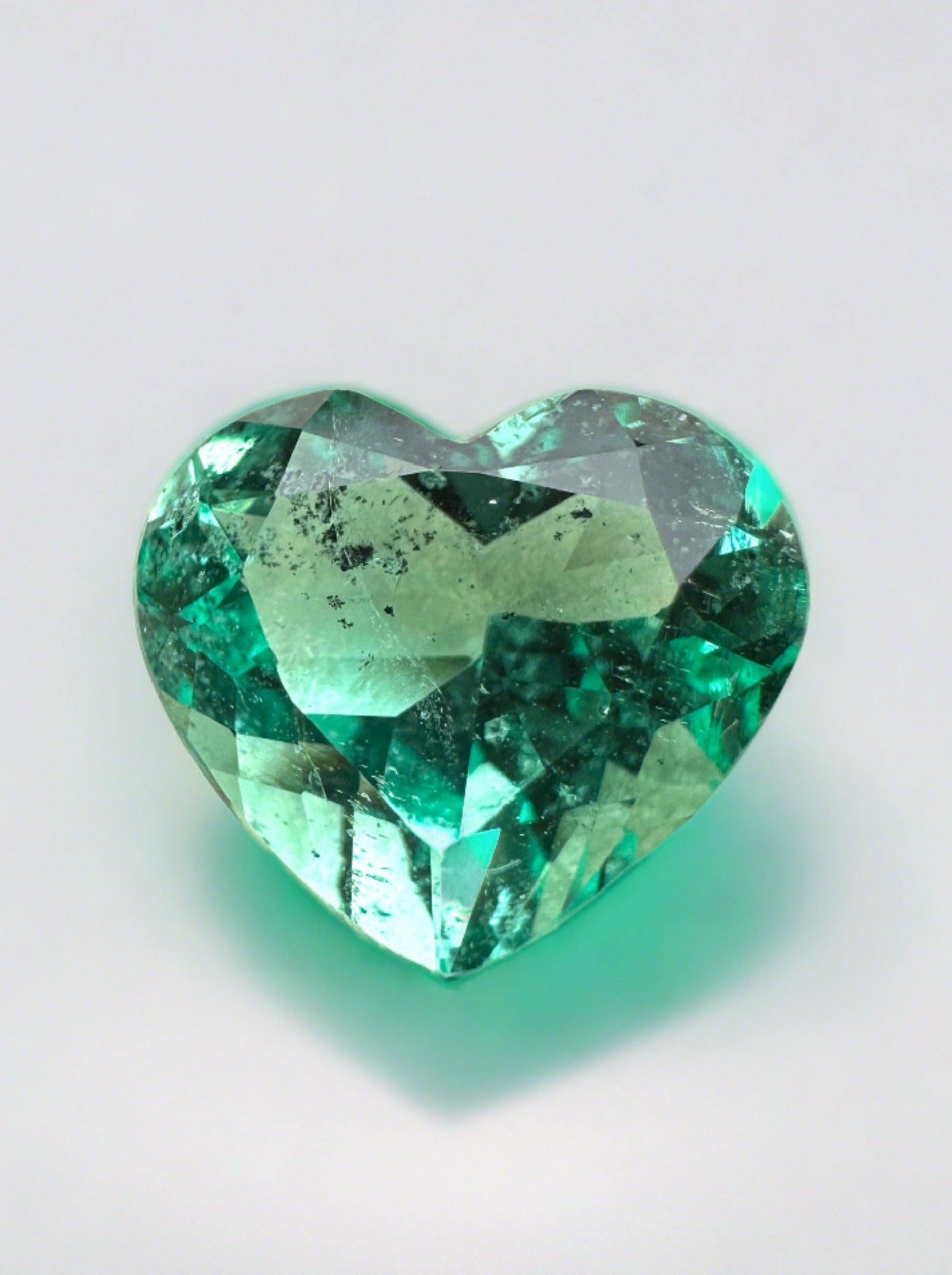 Lustrous 2.87-carat natural Colombian emerald in heart cut, showcasing vibrant green color and clarity.