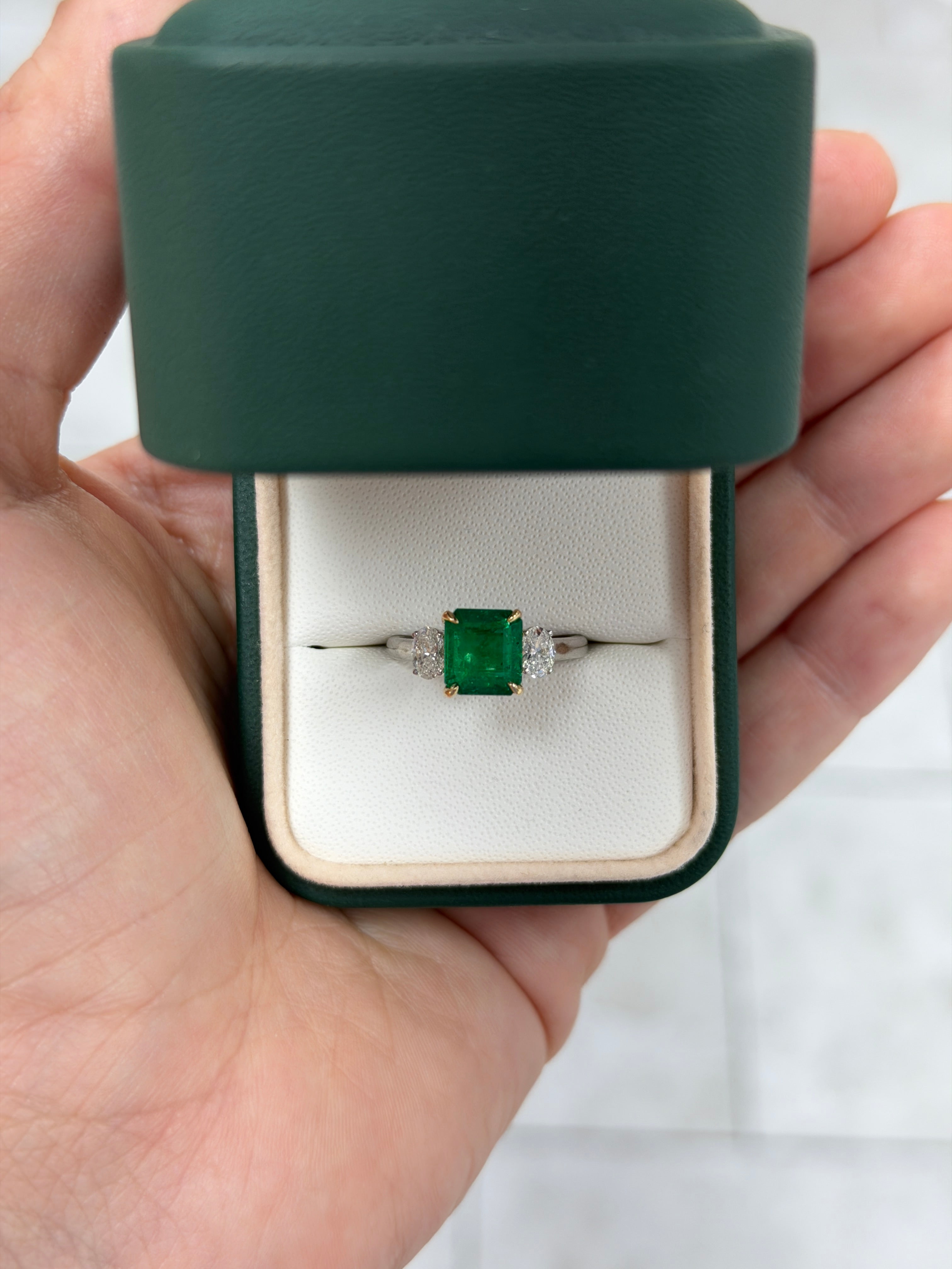 18K white gold three-stone ring with 2.88 tcw Asscher cut emerald and oval diamond by JR Colombian Emeralds