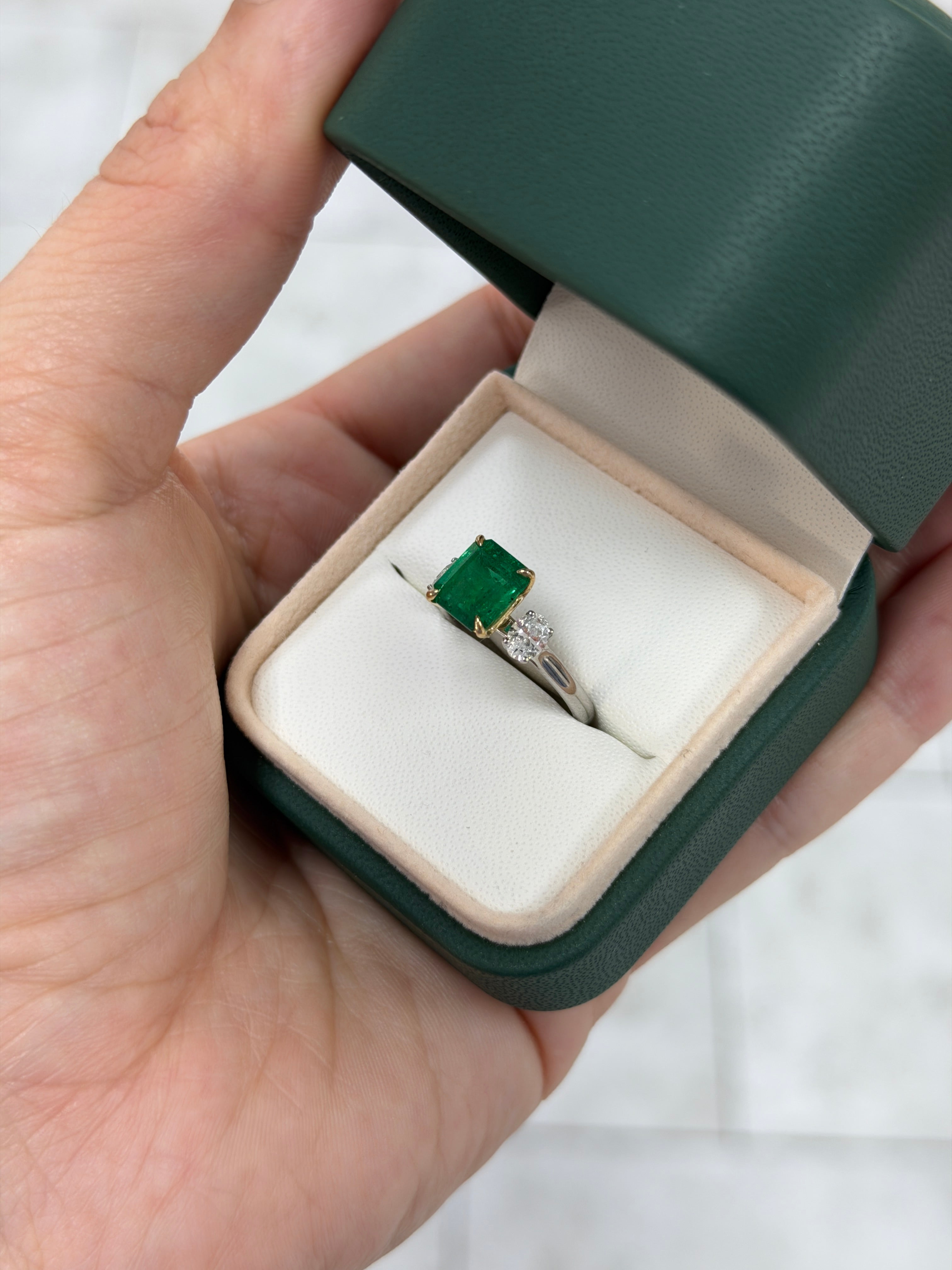 18K Vivid Asscher cut emerald and platinum three-stone ring with oval diamonds, featuring 2.88tcw from JR Colombian Emeralds.