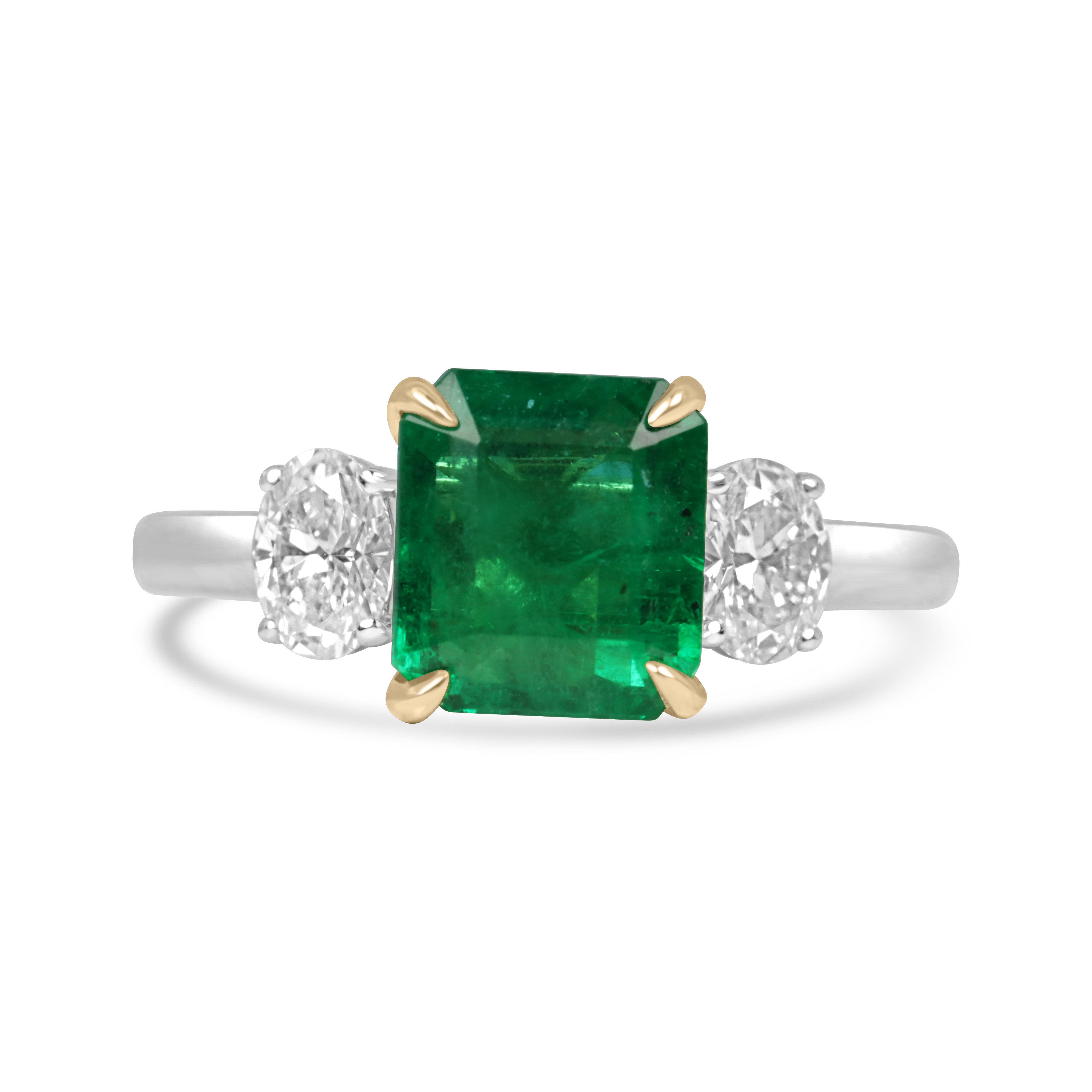 Vivid 2.88tcw 18K gold Asscher cut emerald and platinum oval diamond three-stone ring by JR Colombian Emeralds.