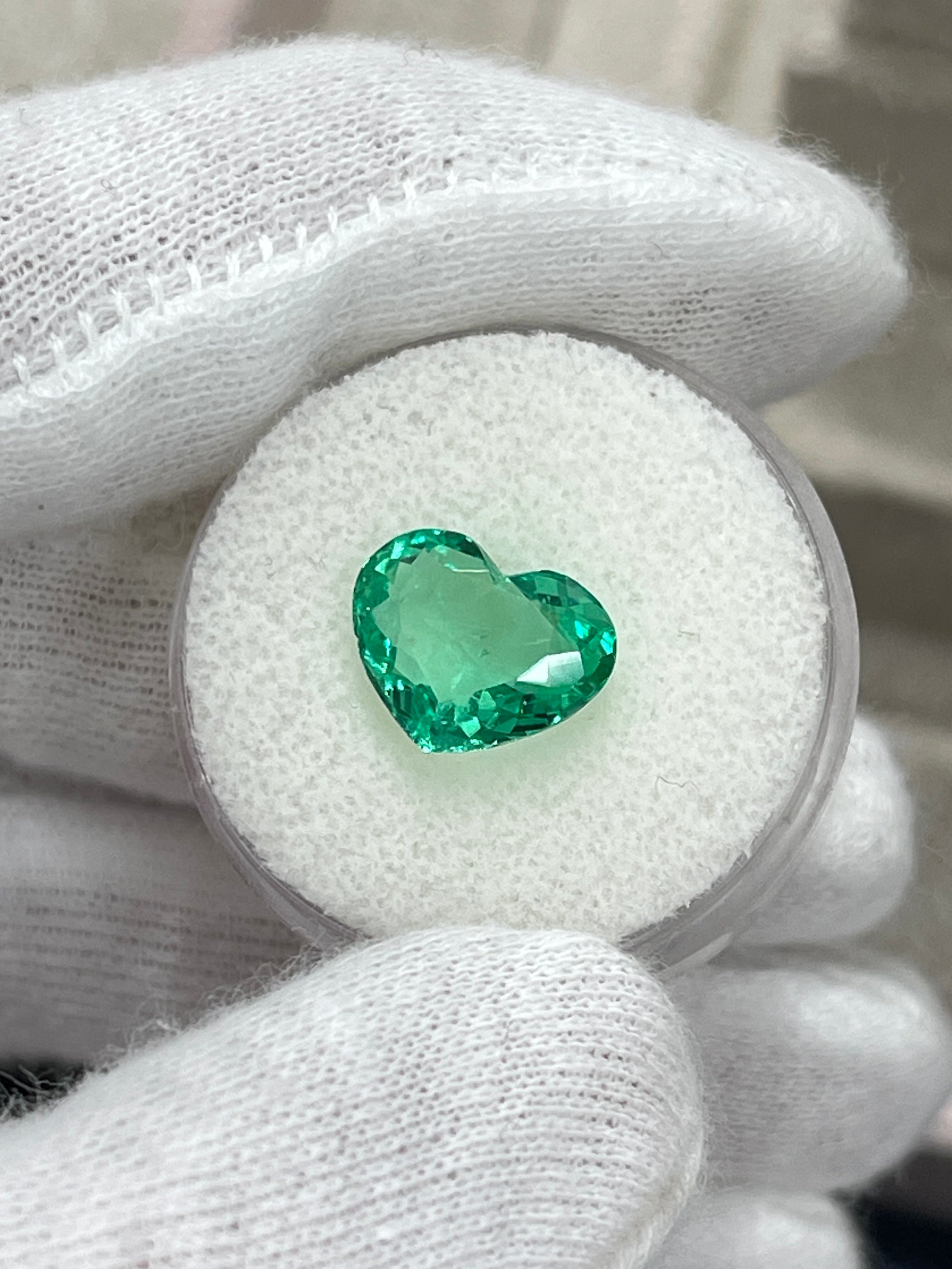 2.91 Carat green Colombian emerald in heart cut, natural loose gemstone from JR Colombian Emeralds, vibrant and glowing.