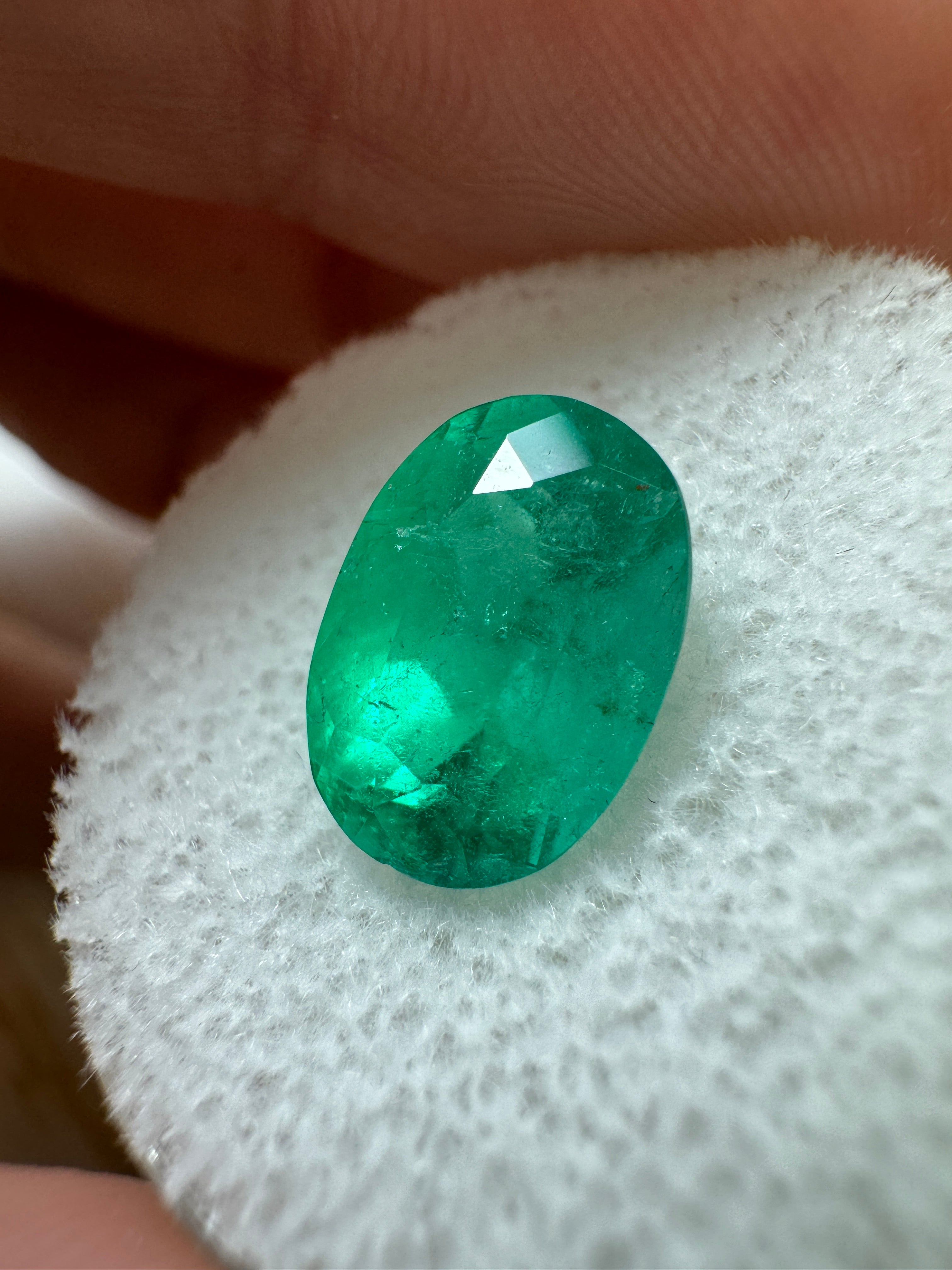 Elongated 2.95 carat semi-transparent green Colombian emerald in oval cut, natural loose gemstone from JR Colombian Emeralds.