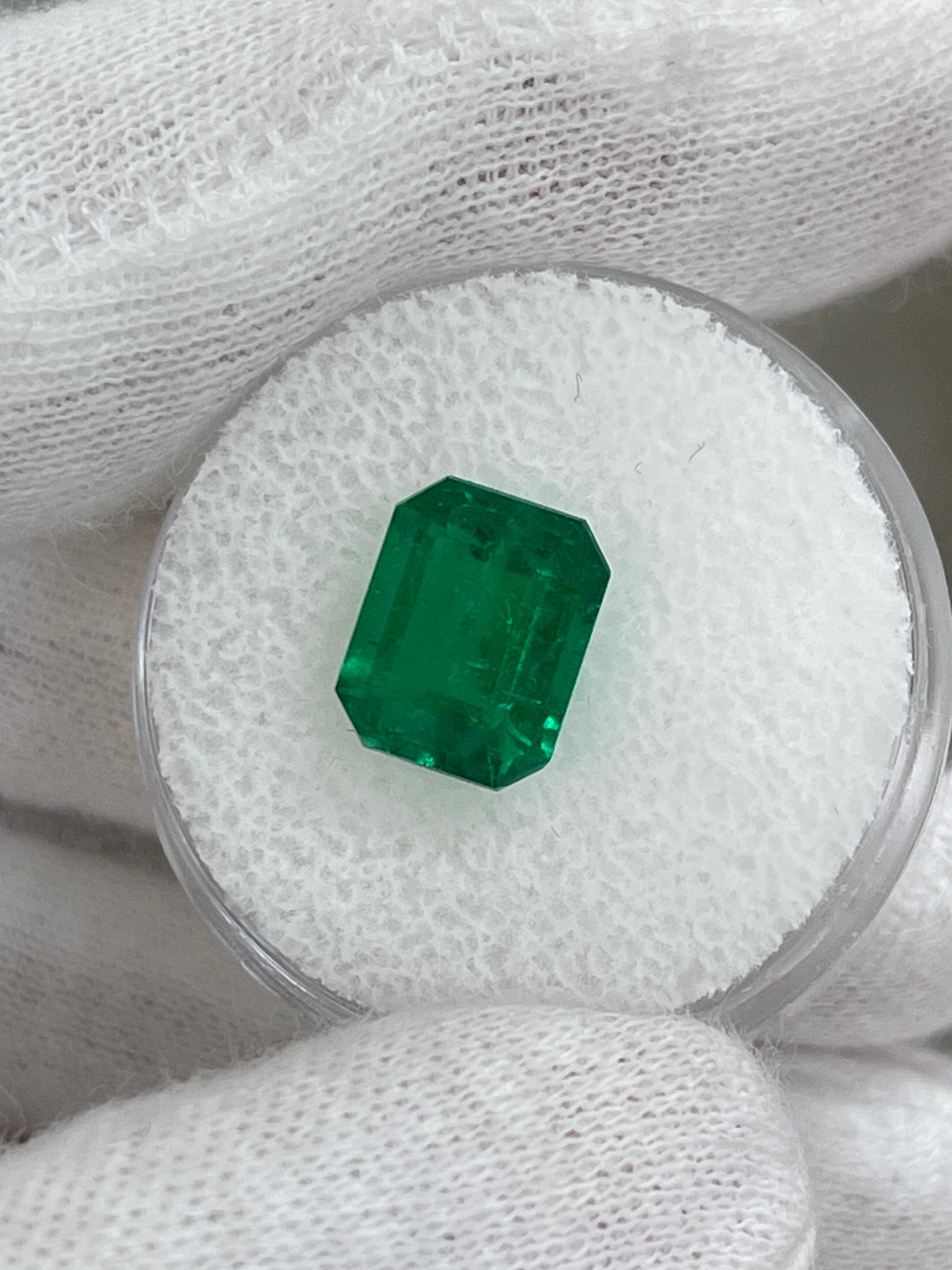 Vivid 3.08 carat Muzo green Colombian emerald loose gemstone in emerald cut, showcasing vibrant color and clarity.