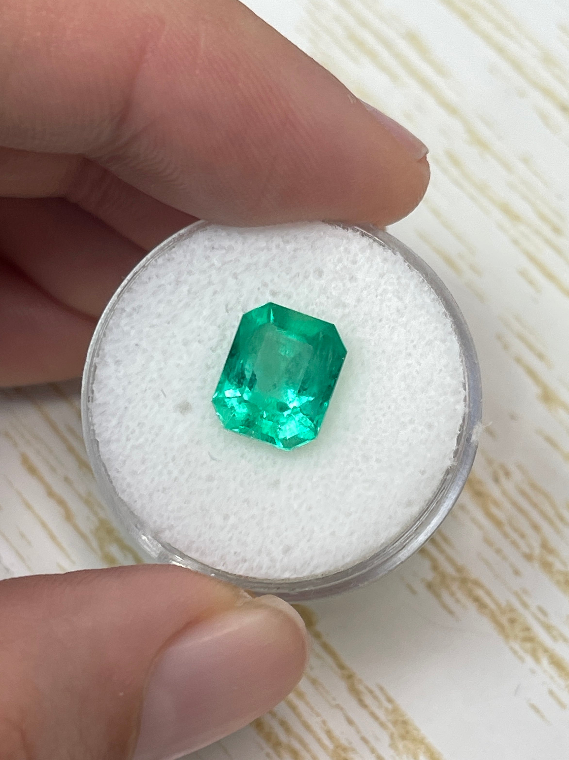 Electric yellowish 3.09 carat Colombian emerald cut gemstone from JR Colombian Emeralds, showcasing vibrant color and clarity.