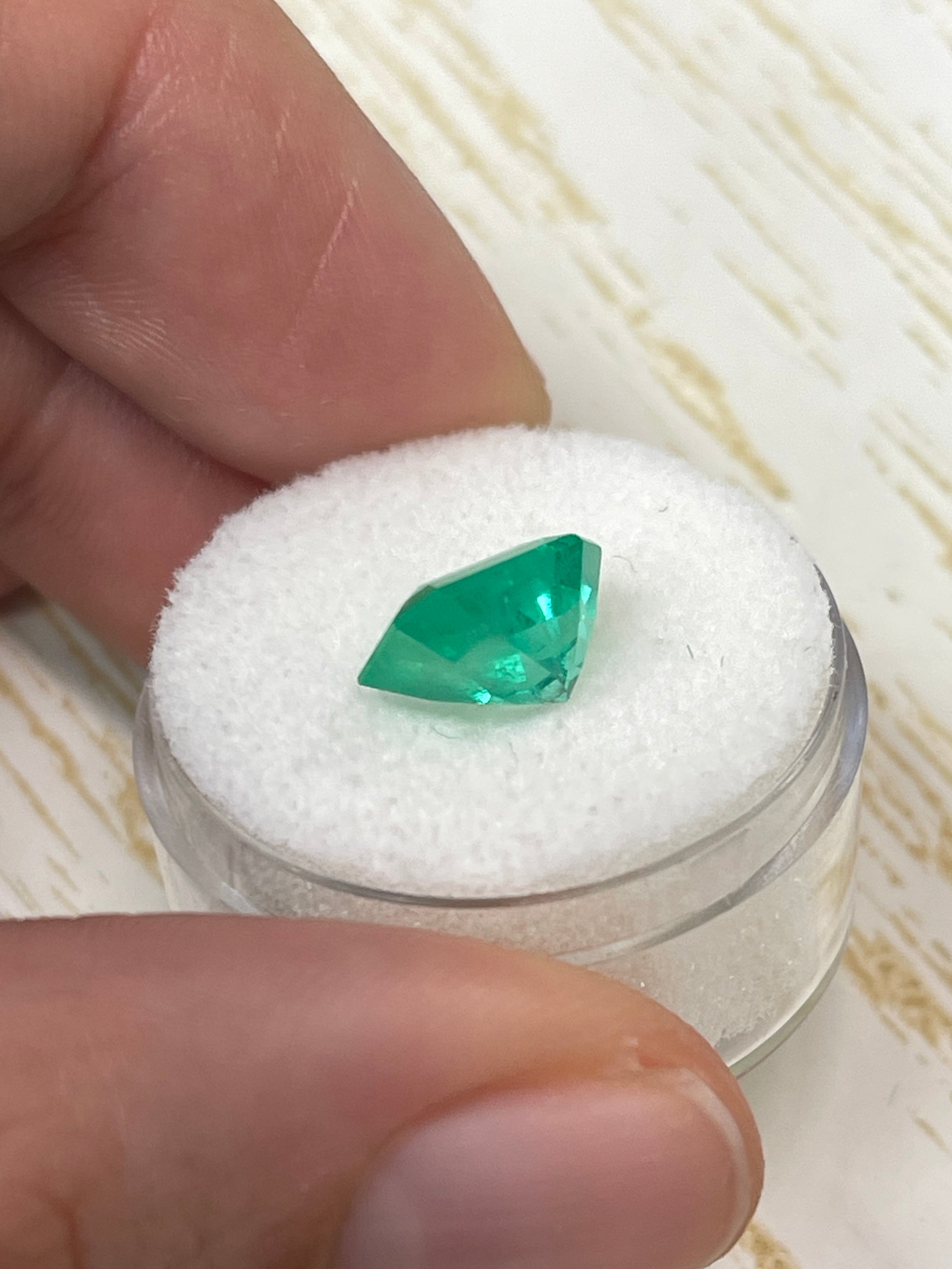 Electric yellowish 3.09 carat Colombian emerald cut gemstone from JR Colombian Emeralds, showcasing vibrant color and clarity.