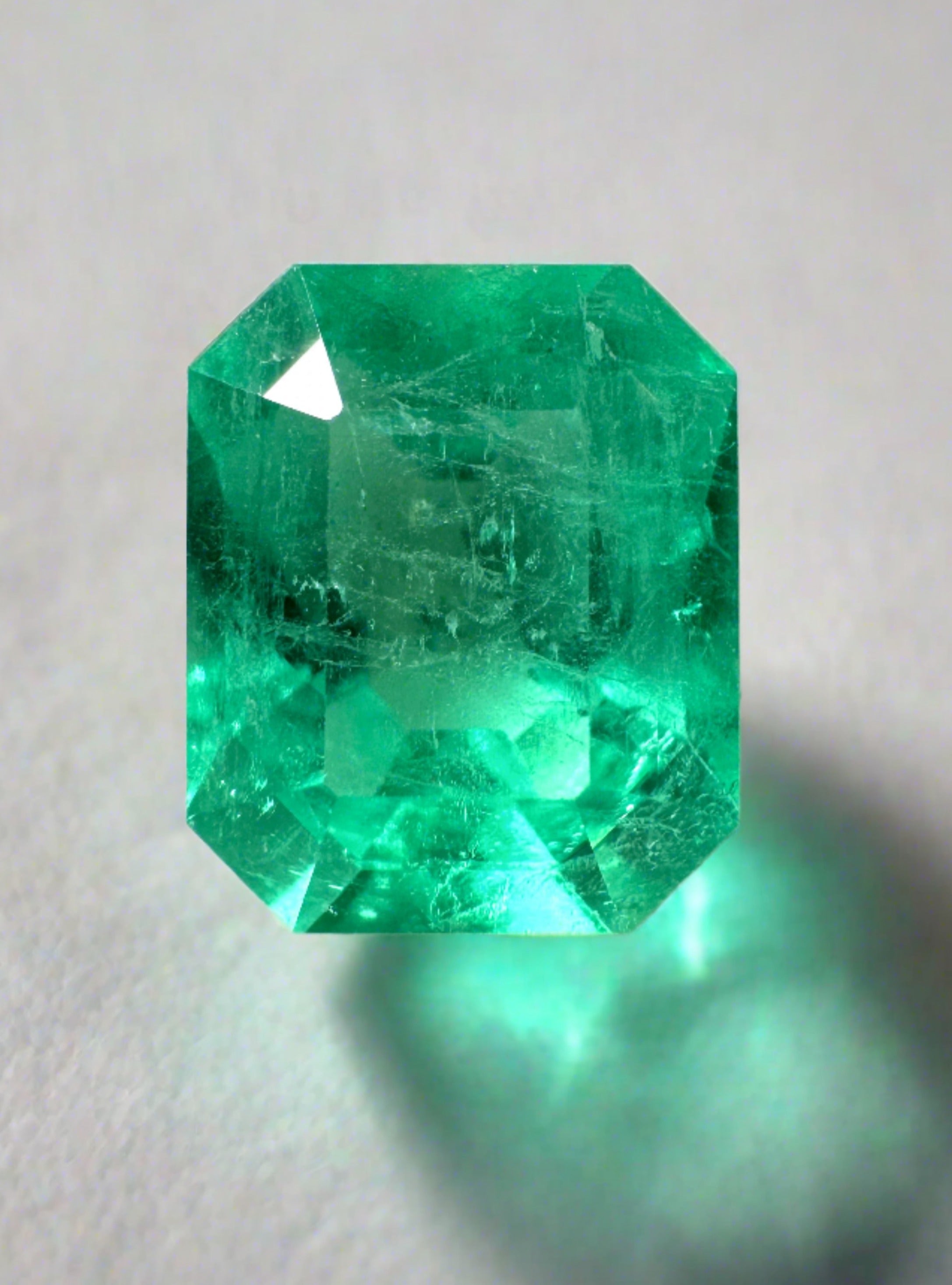 3.09 carat electric yellowish Colombian emerald in 10x8 emerald cut, showcasing vibrant color and clarity, from JR Colombian Emeralds.