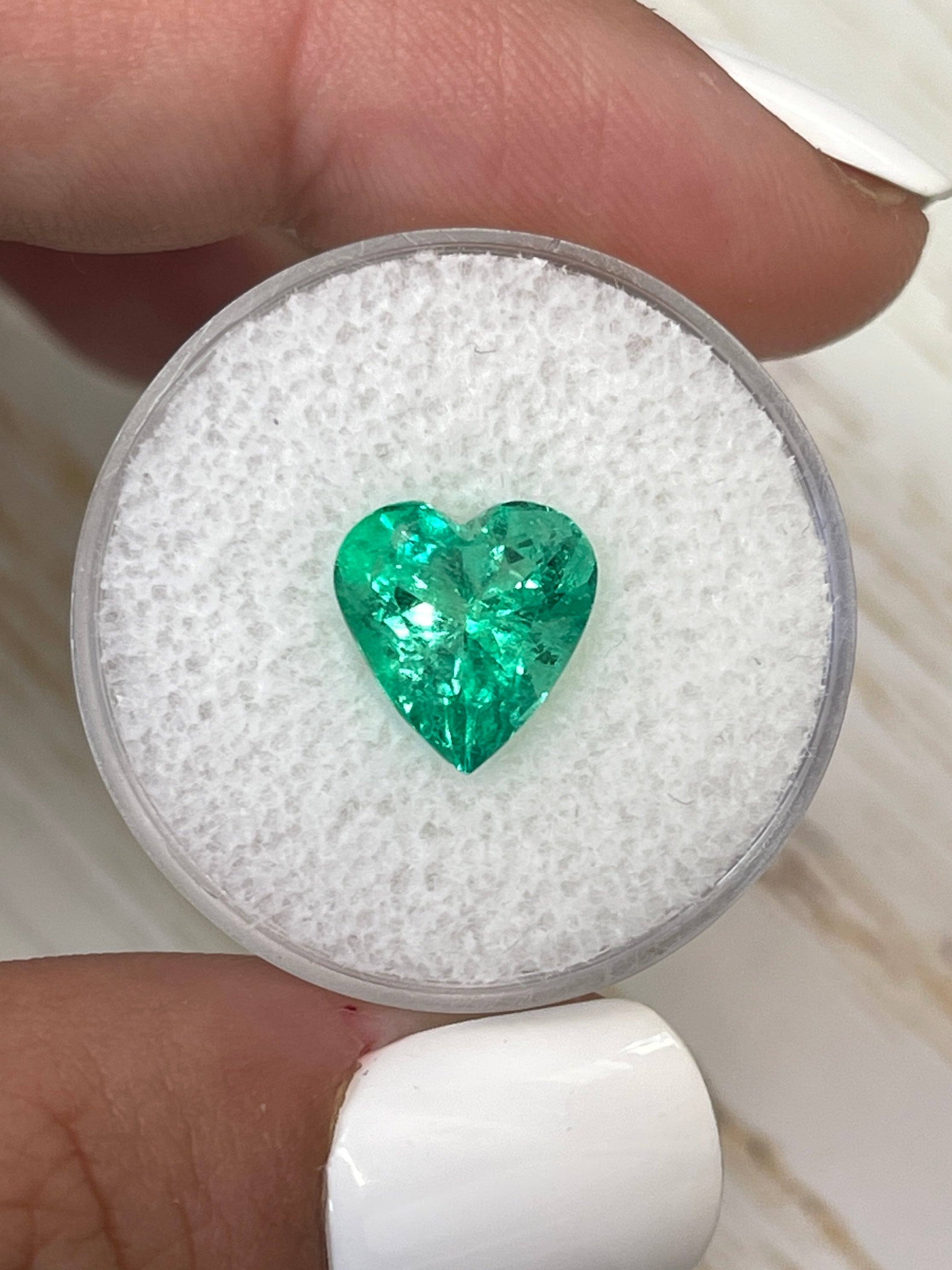 Yellowish green 3.10 carat Colombian emerald loose gemstone with heart cut, natural and radiant, from JR Colombian Emeralds.