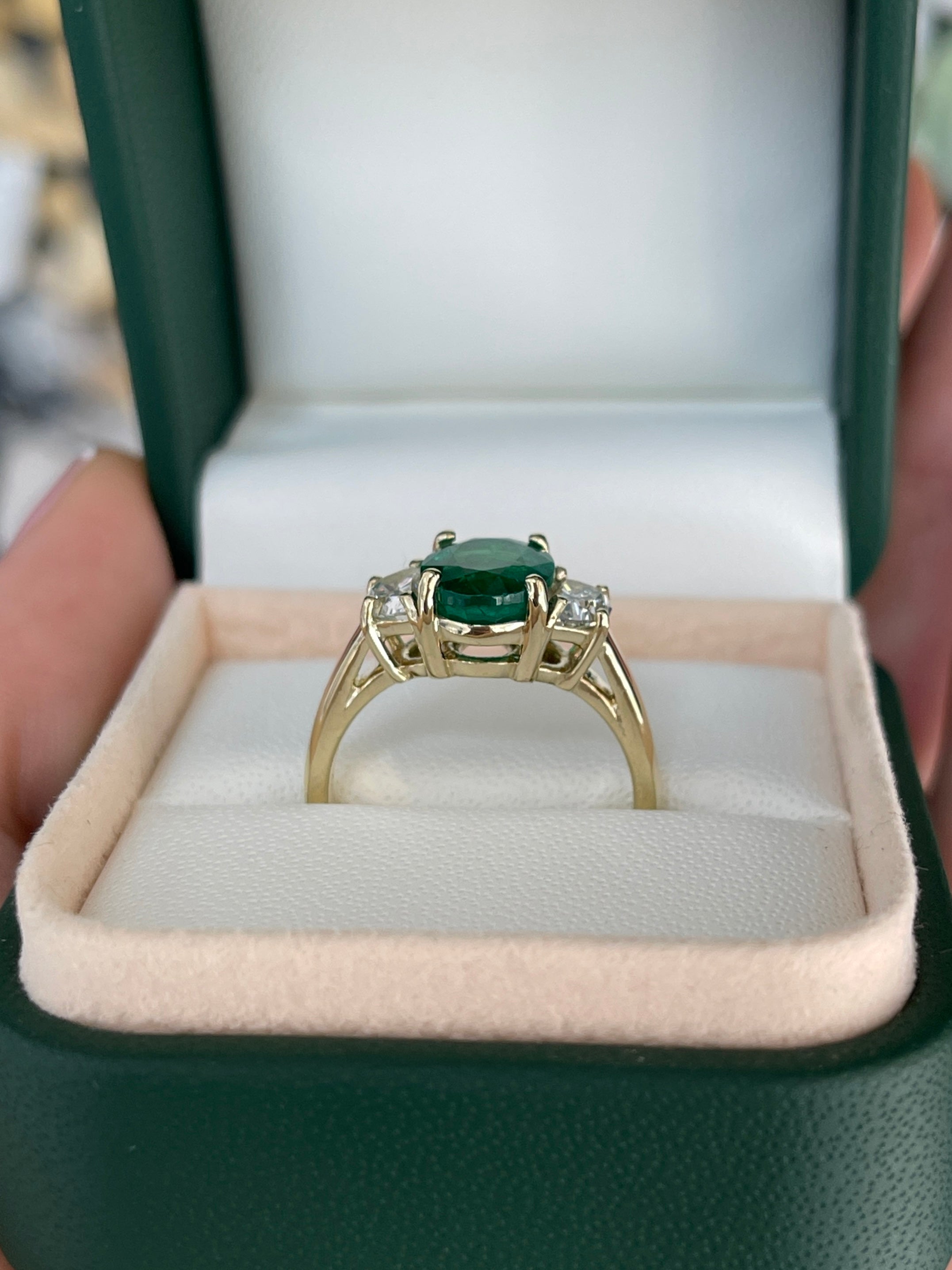 Oval emerald and half moon lab diamond three stone ring in 14K gold, featuring natural gemstones and elegant craftsmanship.