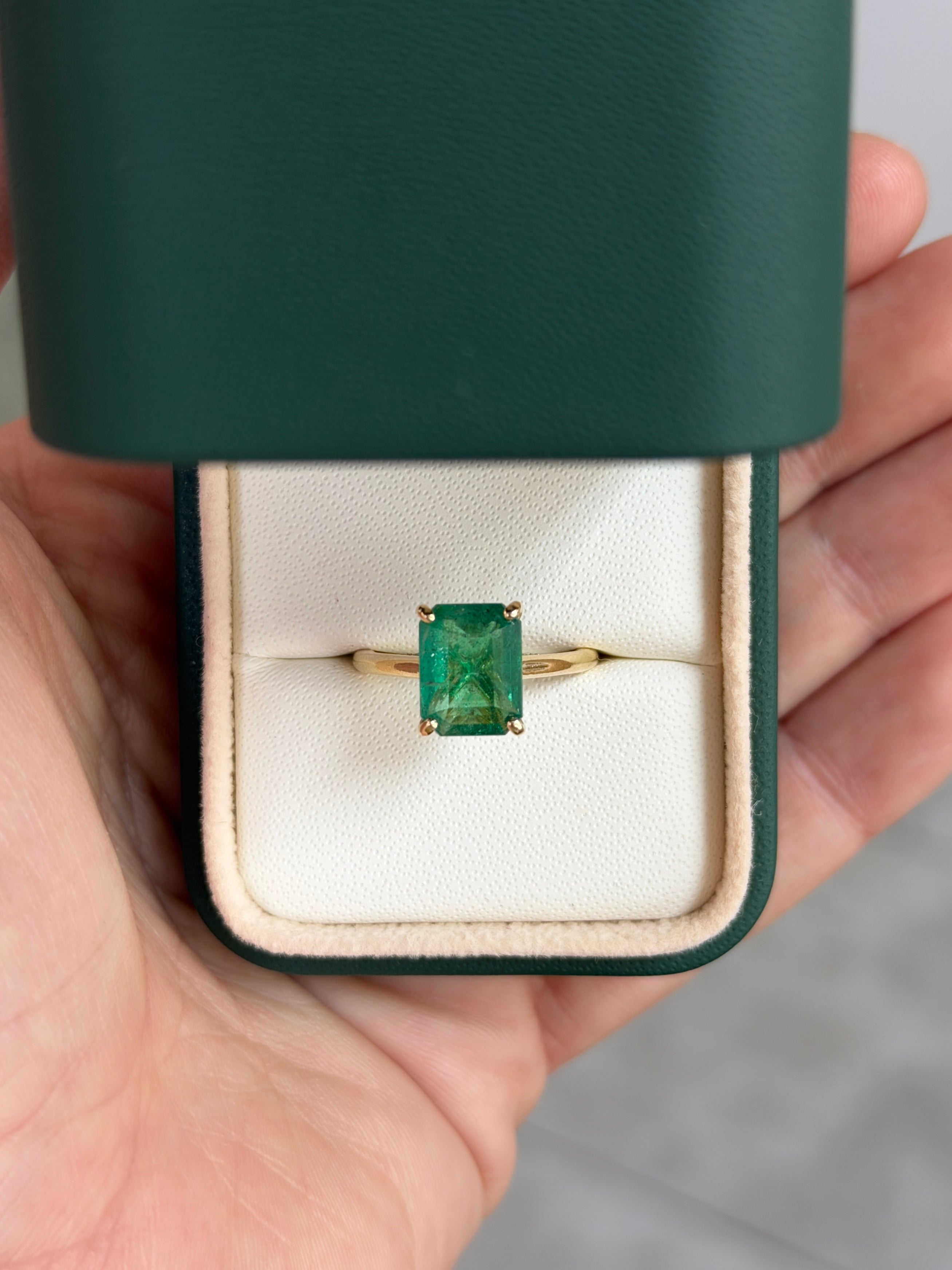 14K gold emerald cut emerald and hidden diamond gallery engagement ring by JR Colombian Emeralds, featuring a stunning central emerald.