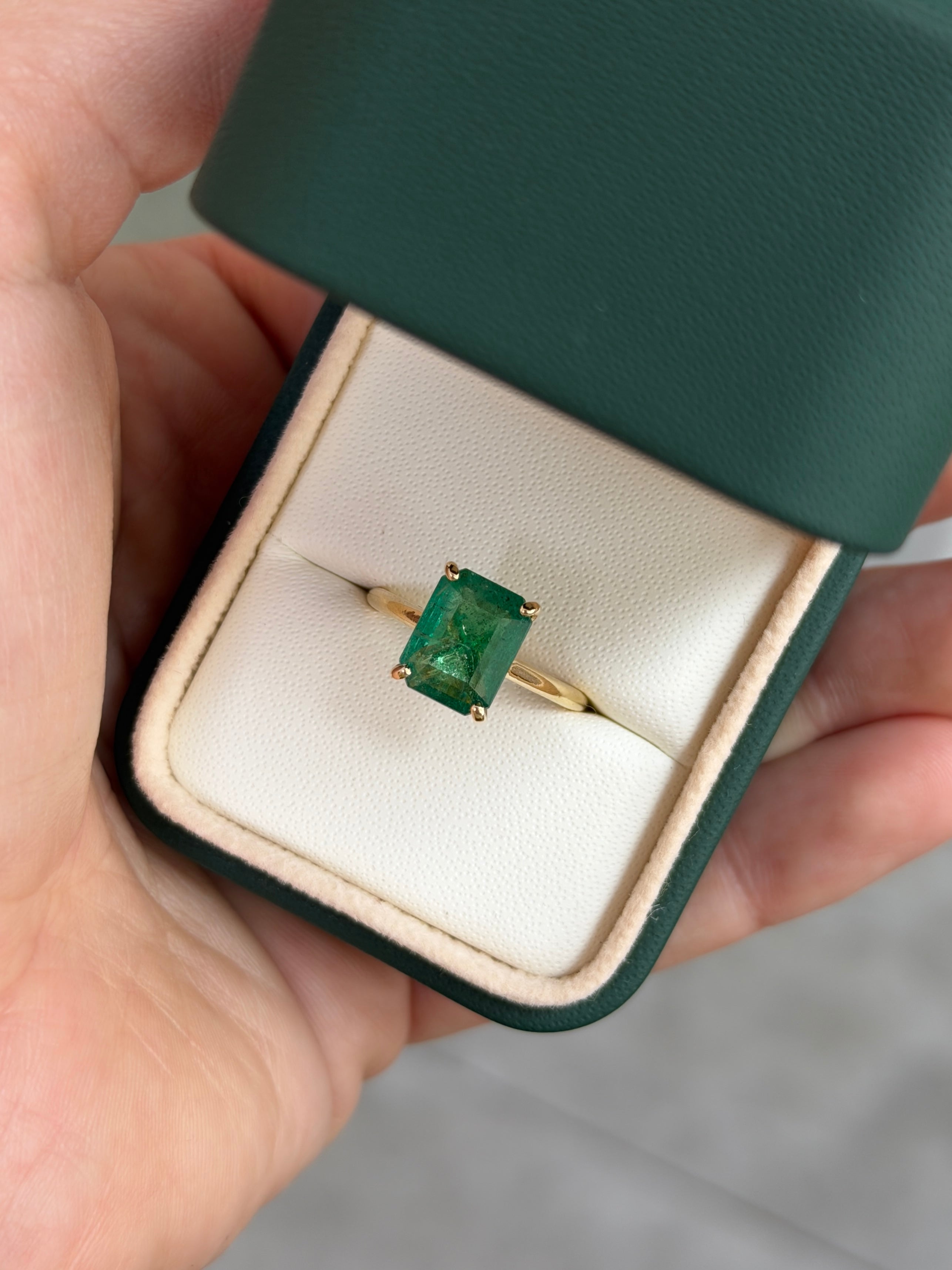 14K gold engagement ring featuring a 3.20tcw emerald cut emerald and hidden diamonds, designed by JR Colombian Emeralds.