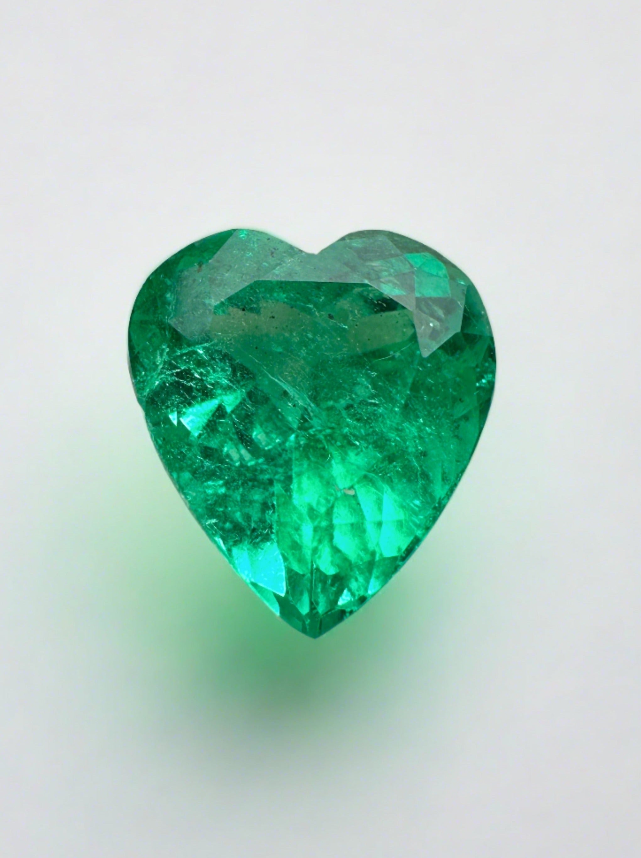 3.22 carat bluish green natural Colombian emerald loose gemstone in heart cut, featuring vibrant color and clarity.