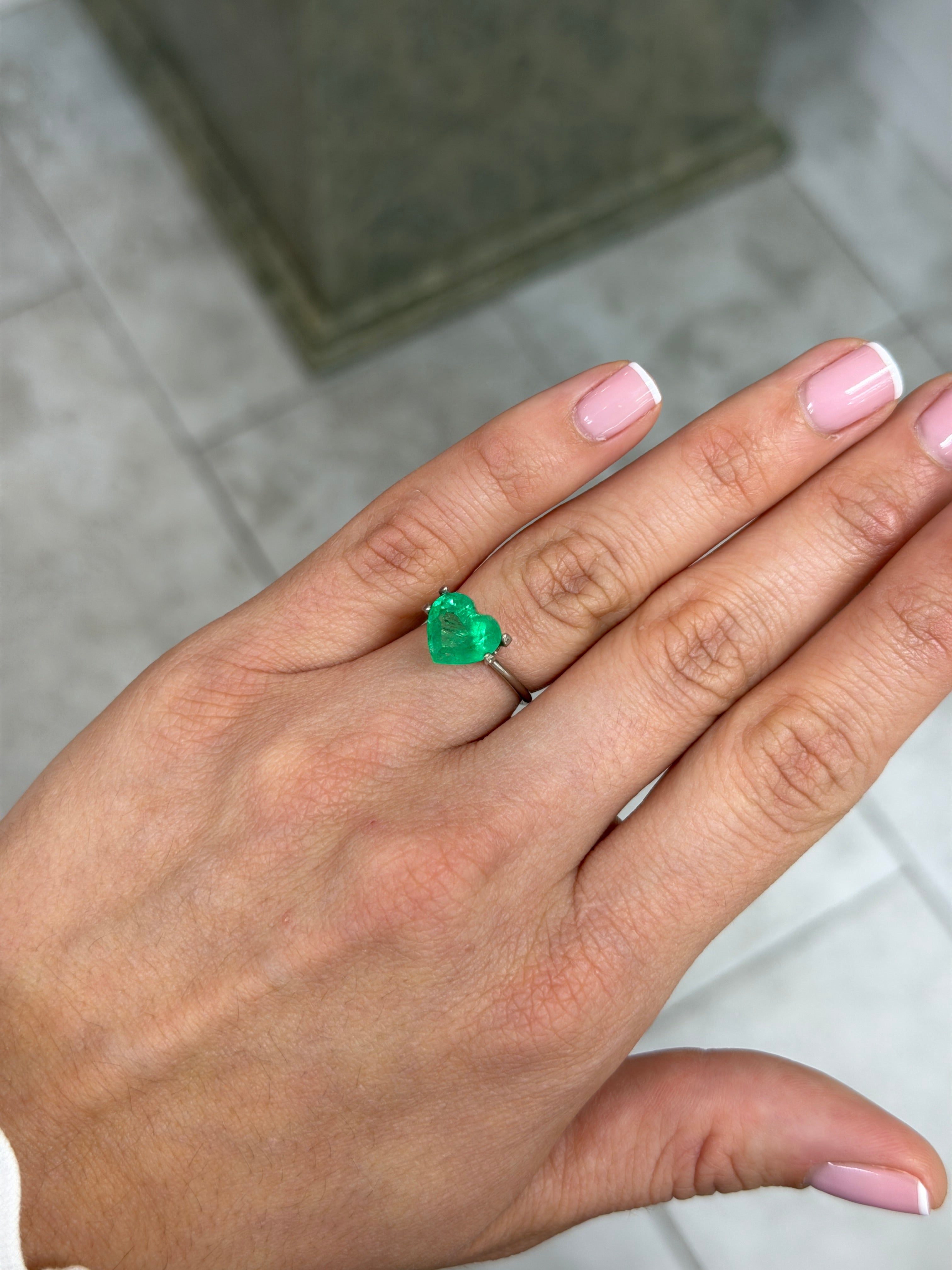 Yellowish-green 3.28 Carat Colombian emerald heart cut, natural loose gemstone with vibrant electric green color.