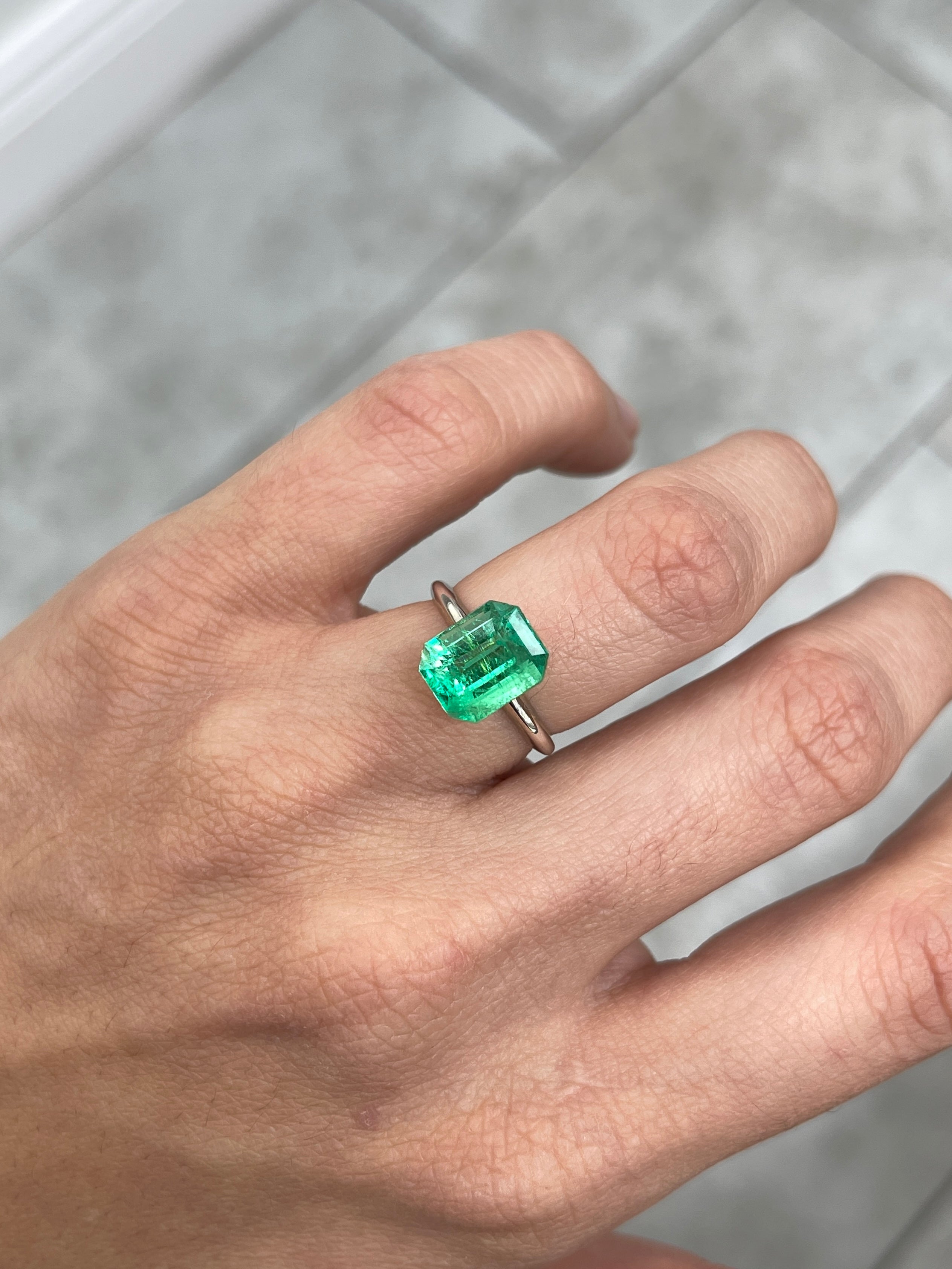 Glowing 3.30 carat natural green Colombian emerald loose gemstone in emerald cut, from JR Colombian Emeralds.