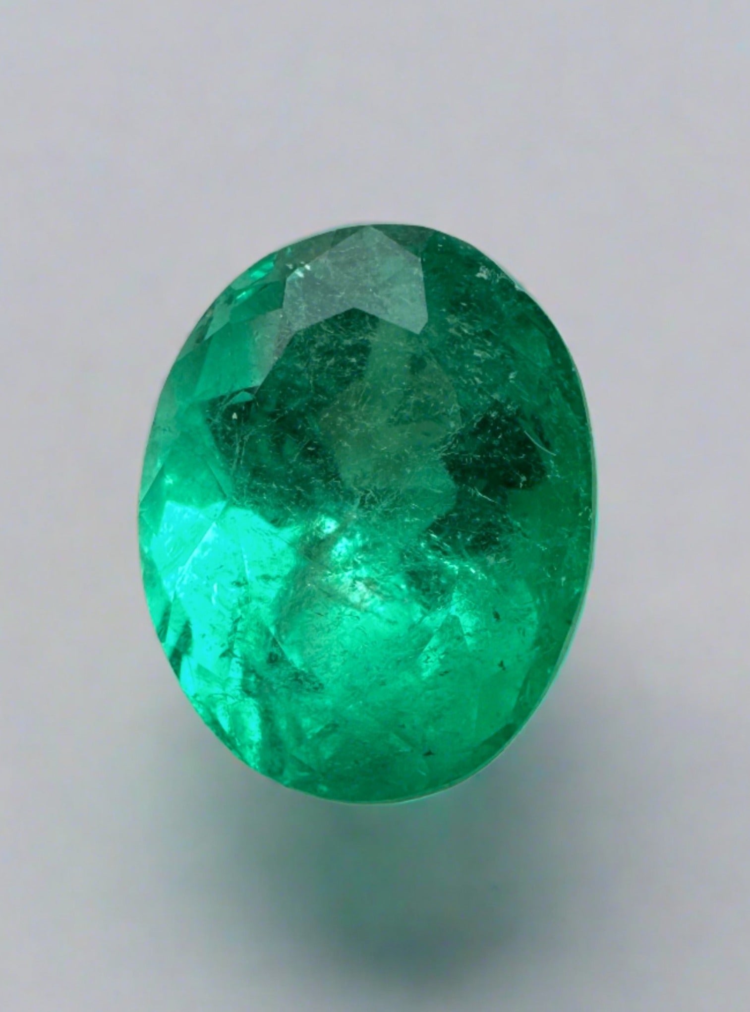 3.32-carat vivacious green natural Colombian emerald loose oval cut gemstone, showcasing vibrant color and clarity.
