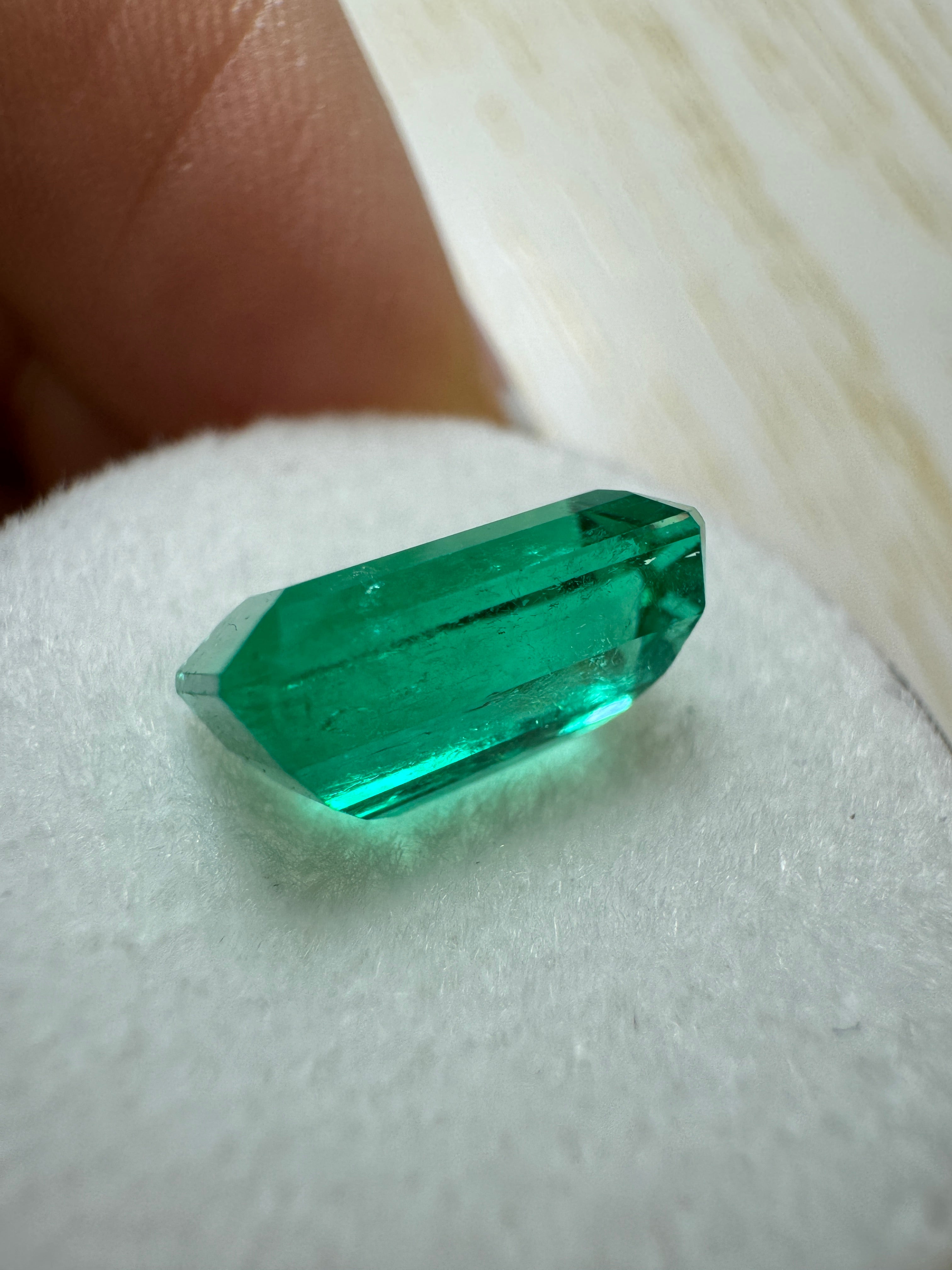 3.40 carat GIA certified vivid bluish green natural Colombian emerald in elongated cut, showcasing clarity and vibrant color.
