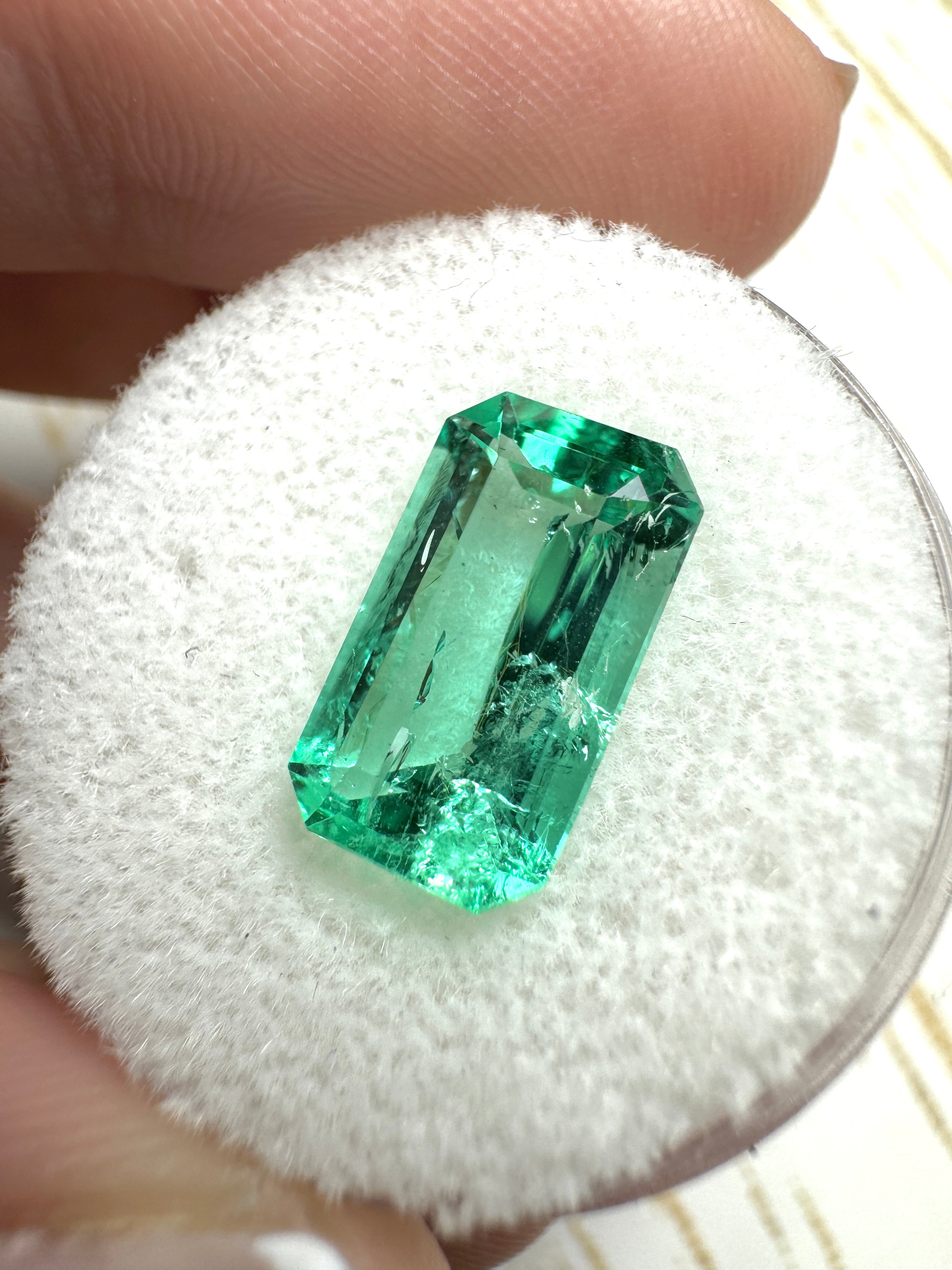 Elongated 3.42 Carat natural Colombian emerald in emerald cut, glowing vibrant green gemstone, loose jewelry stone.