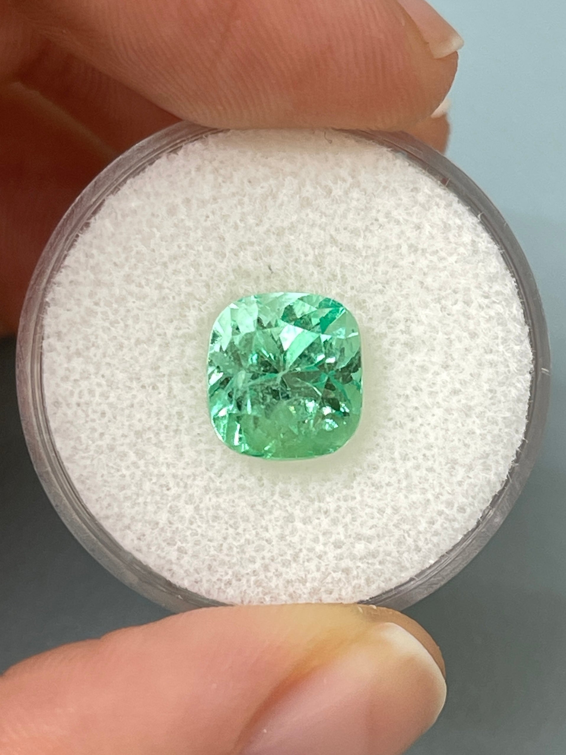 3.42 carat light yellowish-green Colombian emerald in cushion cut, showcasing lustrous natural gemstone clarity and vibrant color.