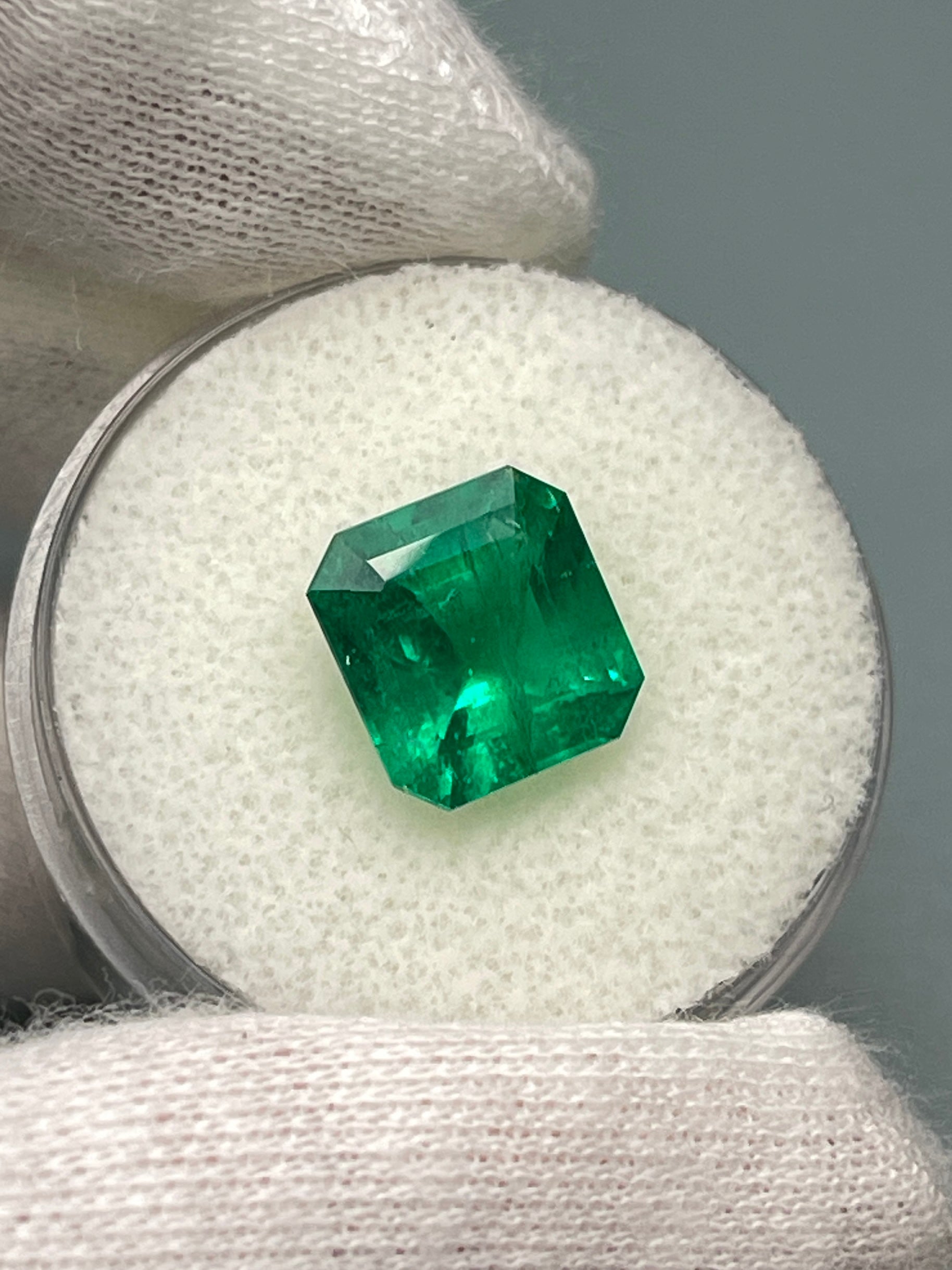 Vivid 3.49 Carat Muzo Green Colombian Emerald in Asscher cut, natural loose gemstone from JR Colombian Emeralds on a white background.