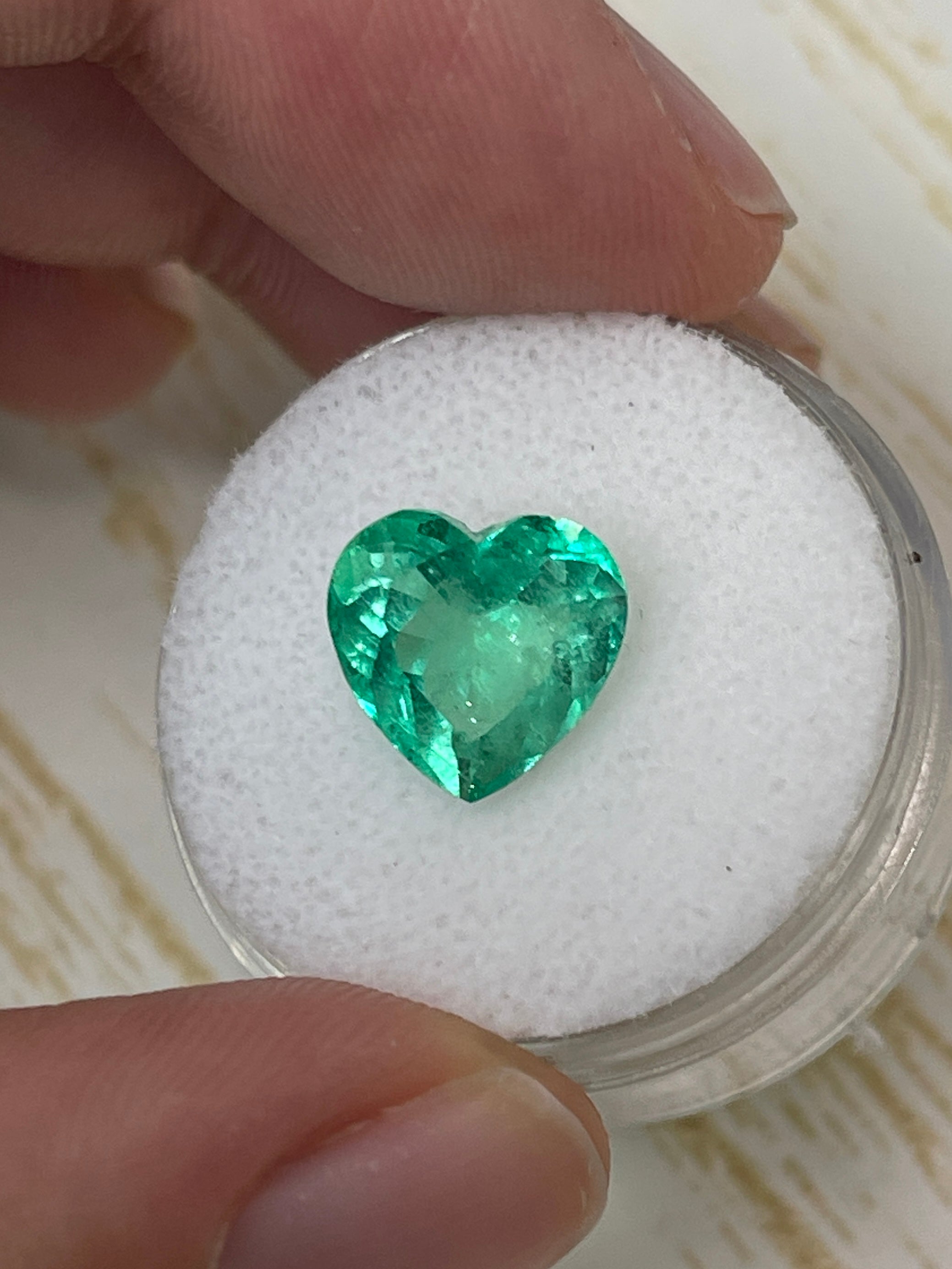 Natural 3.50 carat bubbly green Colombian emerald loose in heart cut, showcasing vibrant color and clarity.