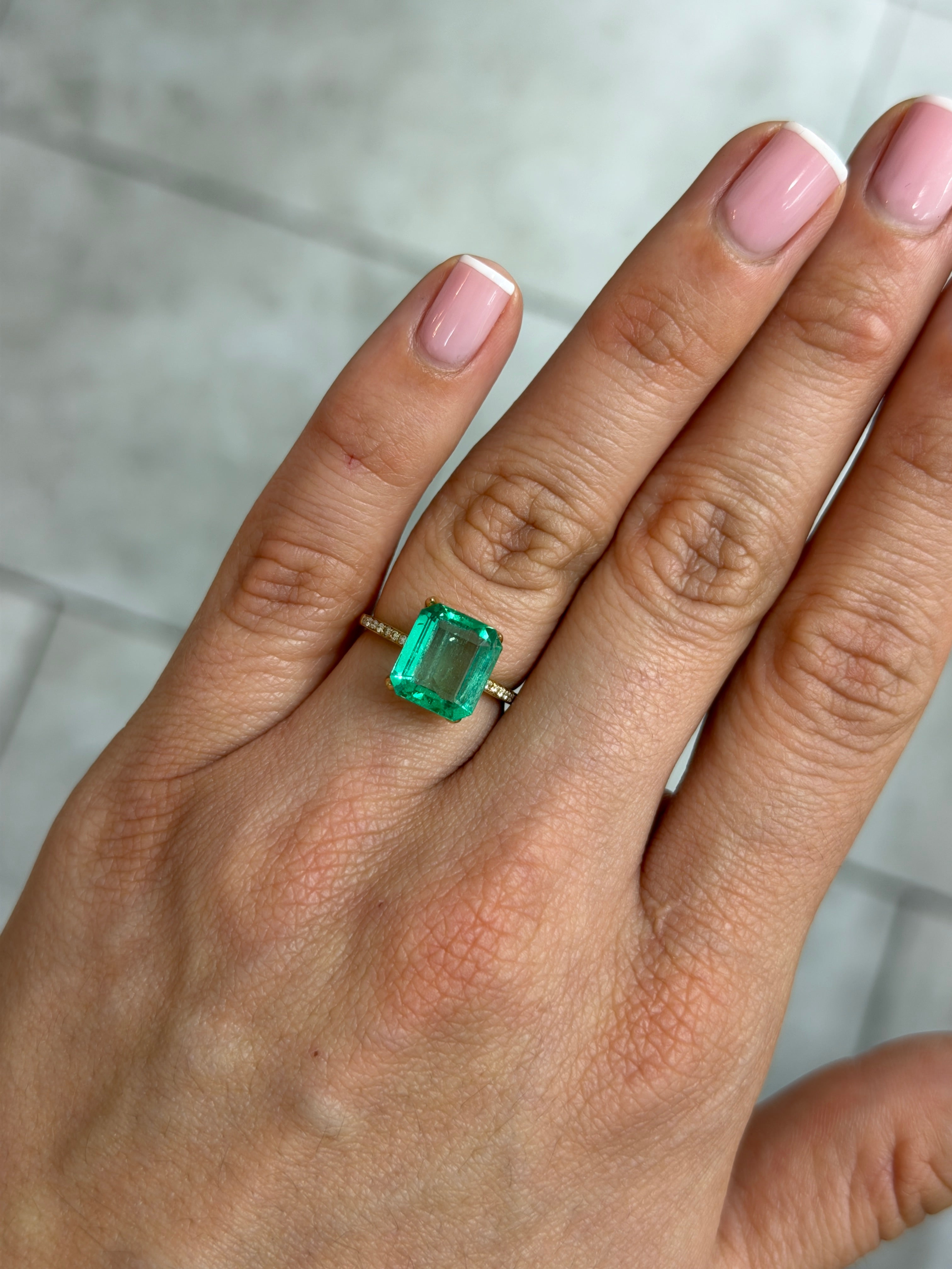 3.54 carat natural Colombian emerald loose gemstone with a portrait cut, vibrant green color, and crystal-clear clarity.