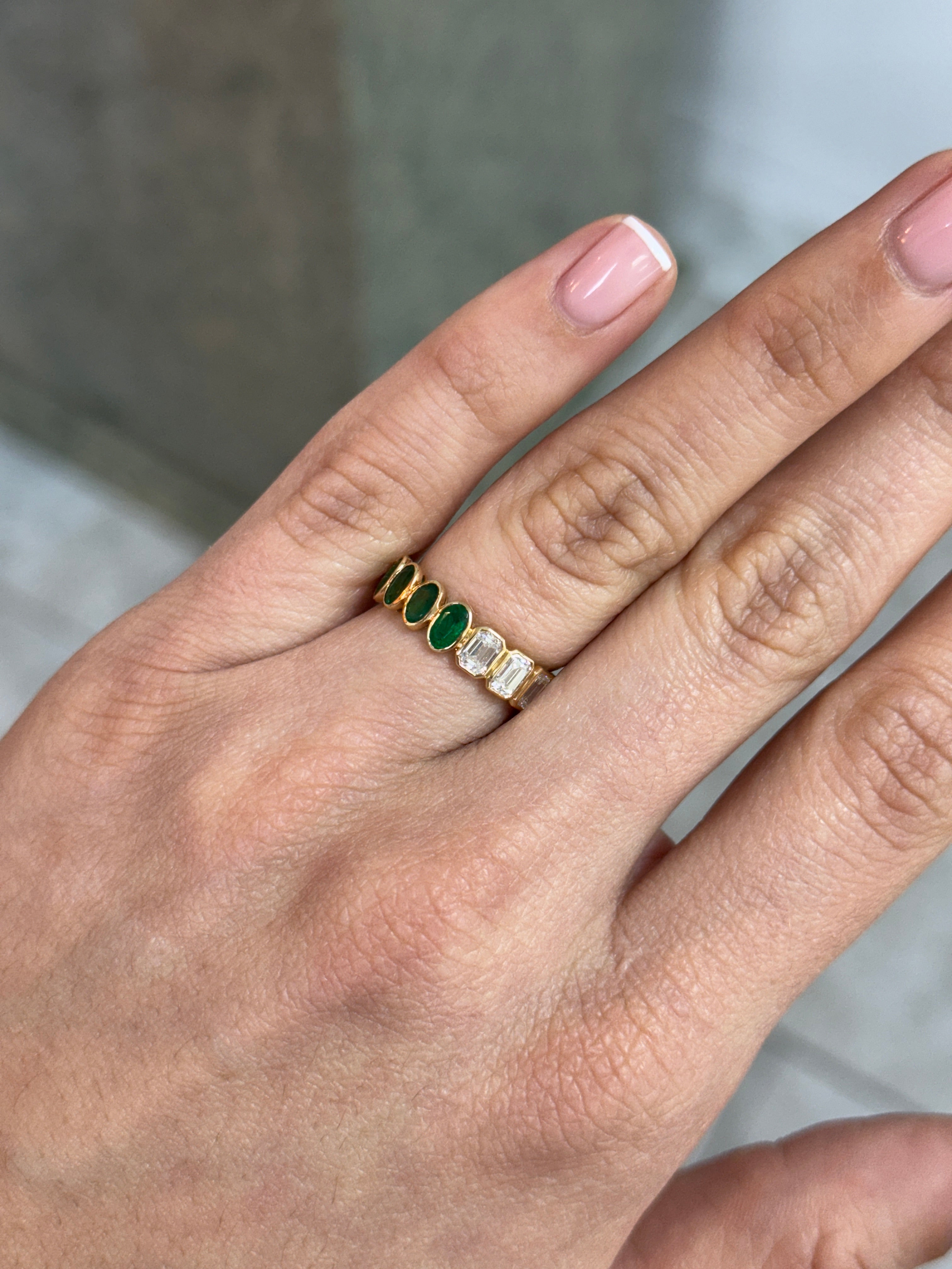 JR Colombian Emeralds 3.65tcw undecided half oval emerald and half emerald cut diamond eternity band in 18K gold, size 6.5.