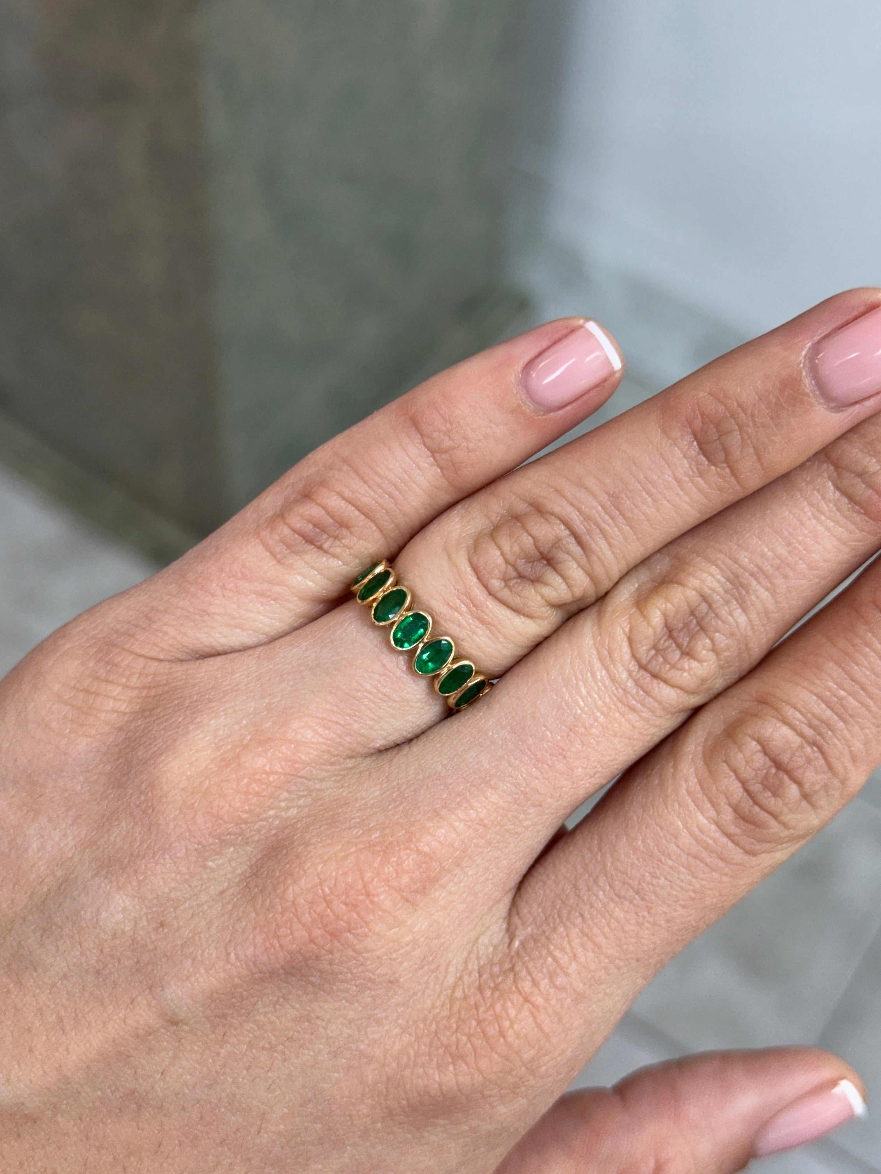 JR Colombian Emeralds 18K eternity band featuring 3.65tcw undecided half oval emeralds and half emerald cut diamonds, size 6.5.